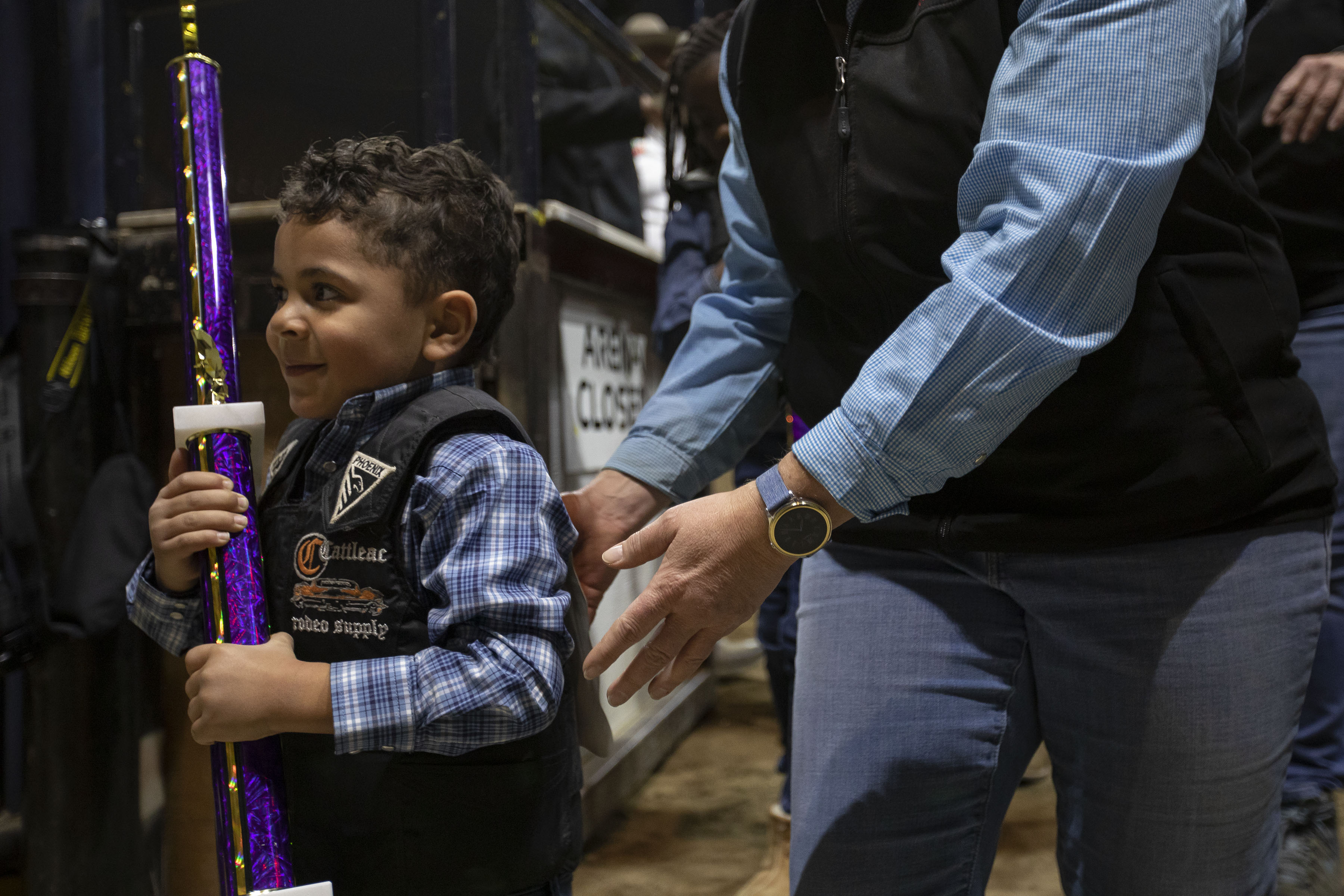 Anthony Yarborough hold on to his trophy while being helped out of the arena after the mitten busting show at the African-American Heritage Rodeo at the National Western Stock Show on Monday, Jan. 17, 2022, in Denver, Colo. (Timothy Hurst/The Gazette) (Timothy Hurst)