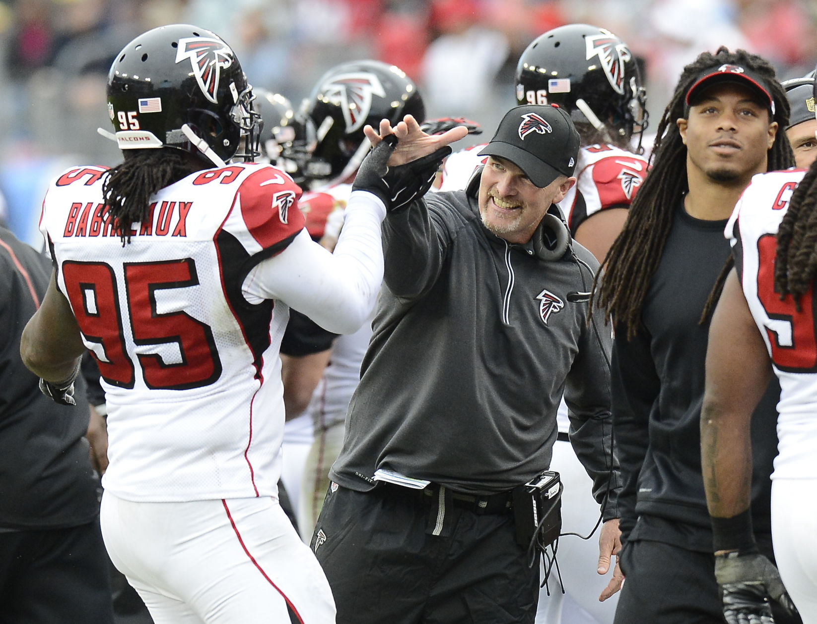 Atlanta Falcons head coach Dan Quinn, center, congratulates nose tackle Jonathan Babineaux (95) after a play against the Tennessee Titans in the second half of an NFL football game Sunday, Oct. 25, 2015, in Nashville, Tenn. (AP Photo/Mark Zaleski) (Mark Zaleski)