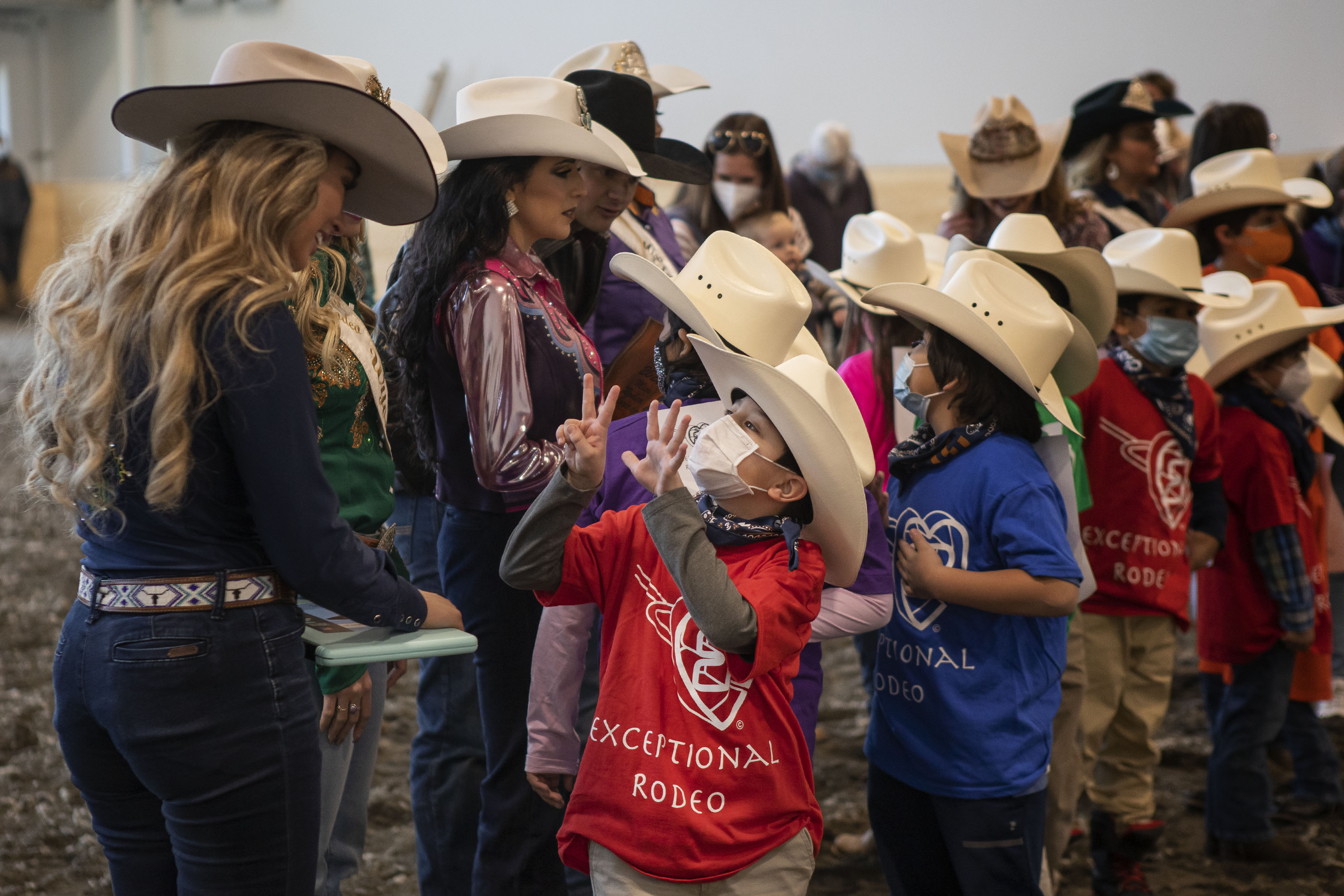 Second grader RyLeigh Vigil, 7, shows and tells Miss Rodeo South Dakota Adrianne Schaunaman his age as they pair off together to participate in the Exceptional Rodeo in the Temple Grandin Equine Center on Thursday, Jan. 20, 2022, at the CSU Spur Campus in Denver, Colo. (Timothy Hurst/The Gazette) (Timothy Hurst)
