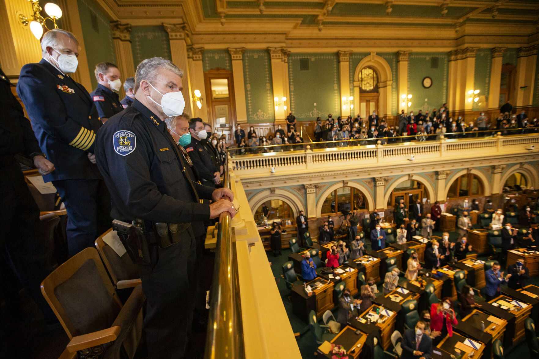 Louisville Police Chief David Hayes, who lost his home along with 1000 other residences lost in the recent Marshall Fire, receives a standing ovation from the floor and gallery during Gov. Jared Polis’ State of the State address on Thursday, Jan. 13, 2022, in Denver, Colo. (Timothy Hurst/The Gazette) (Timothy Hurst)