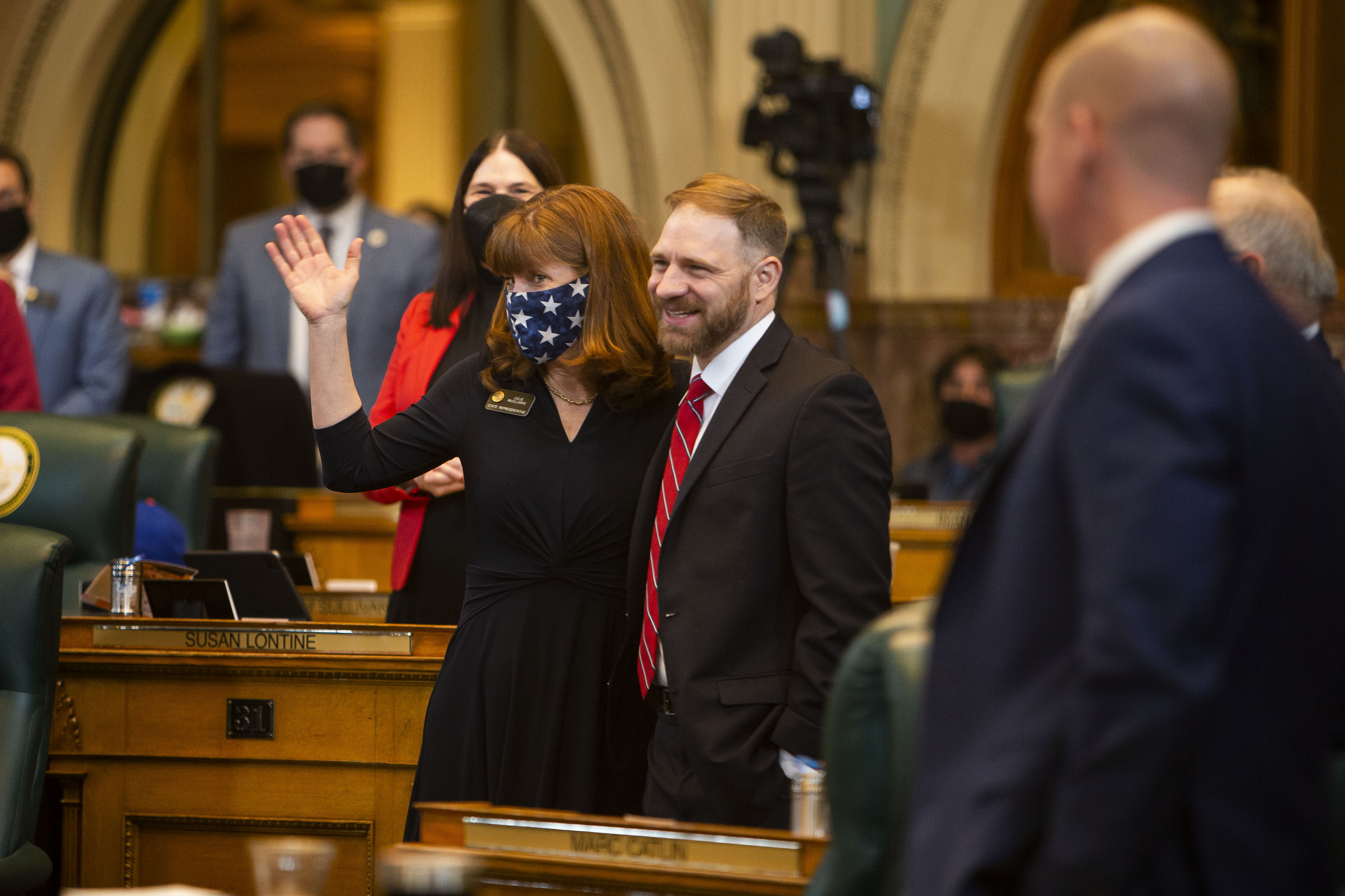 Rep. Julie McCluskie waves with Rep. Kevin Van Winkle while house Republicans and Democrats sing “Happy Birthday” to McCluckie during the first day of Colorado’s 2022 session at the Colorado State Capitol building on Wednesday, Jan. 12, 2022, in Denver, Colo. (Timothy Hurst/The Gazette) (Timothy Hurst)