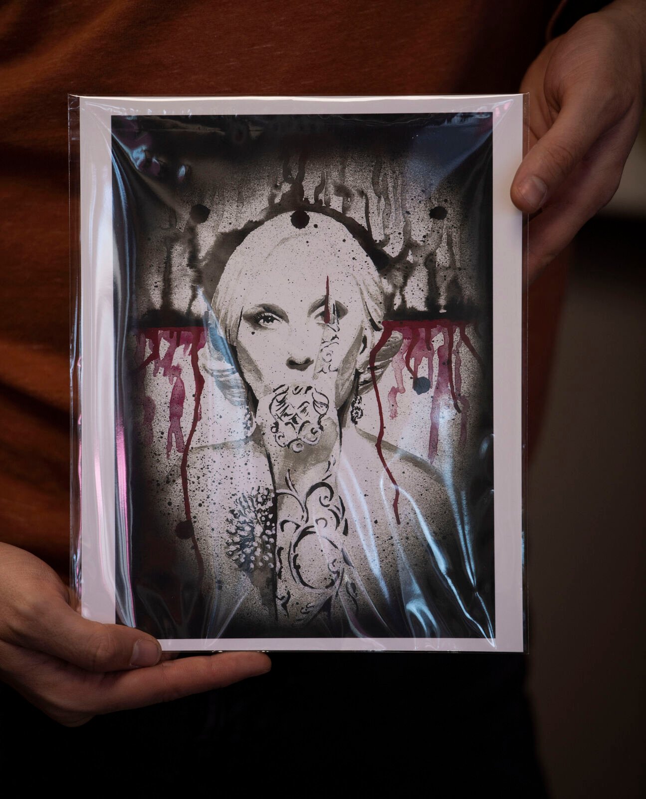 LEFT:Cronkholds his favorite American Horror Story drawing he created of Lady Gaga at his new store in downtown Colorado Springs onDec. 18. (Chancey Bush, The Gazette)
