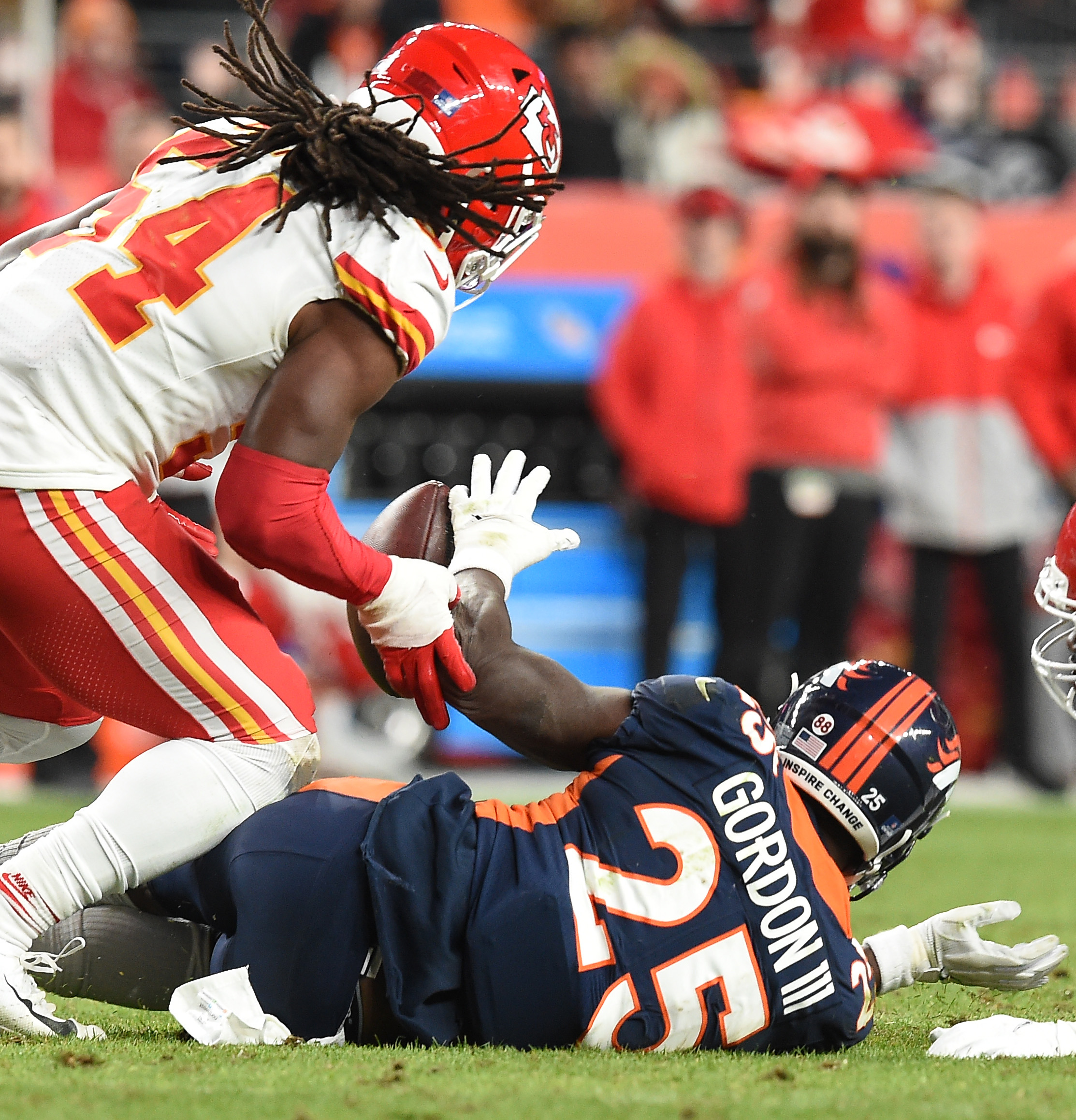 Broncos running back Melvin Gordon III fumbles the ball and Chiefs linebacker Nick Bolton recovered it and ran it to the end zone for a Chiefs touchdown in a game at Empower Field at Mile High on Saturday, Jan. 8, 2022. The Broncos were moving the ball down the field and possibly The Broncos lost to the Chiefs 28-24. (Photo by Jerilee Bennett, The Gazette) (Jerilee Bennett)