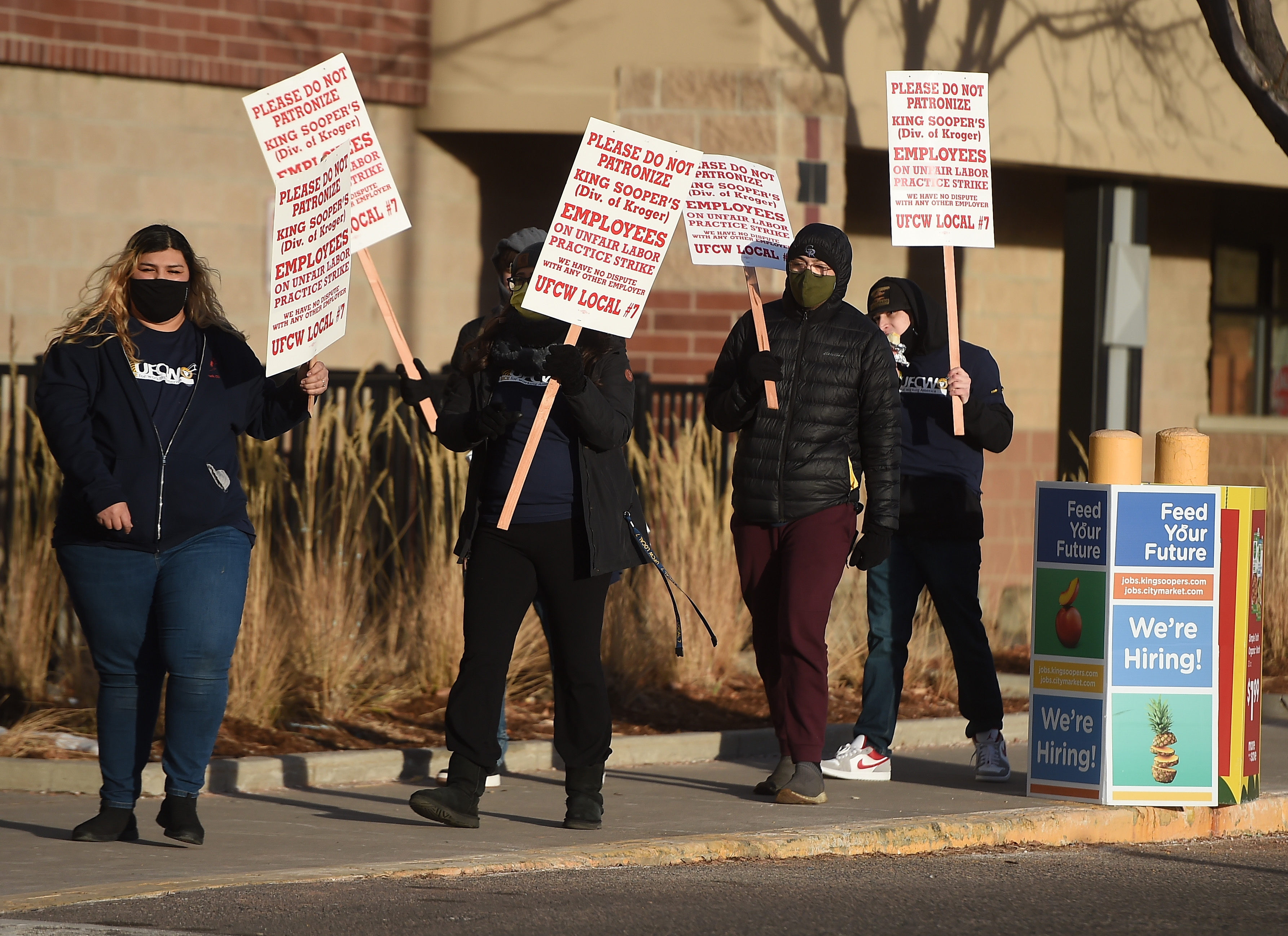 A grocery shopper walks out of King Soopers past protester Rafael Martinez. The union workers from many metro Denver area King Soopers went on strike at 5 a.m. Wednesday. At the Stroh Ranch King Soopers on south Parker Road in Parker picketers were out in force early Wednesday morning on Jan. 12, 2022. (Photo by Jerilee Bennett, The Gazette) (Jerilee Bennett/The Denver Gazette)