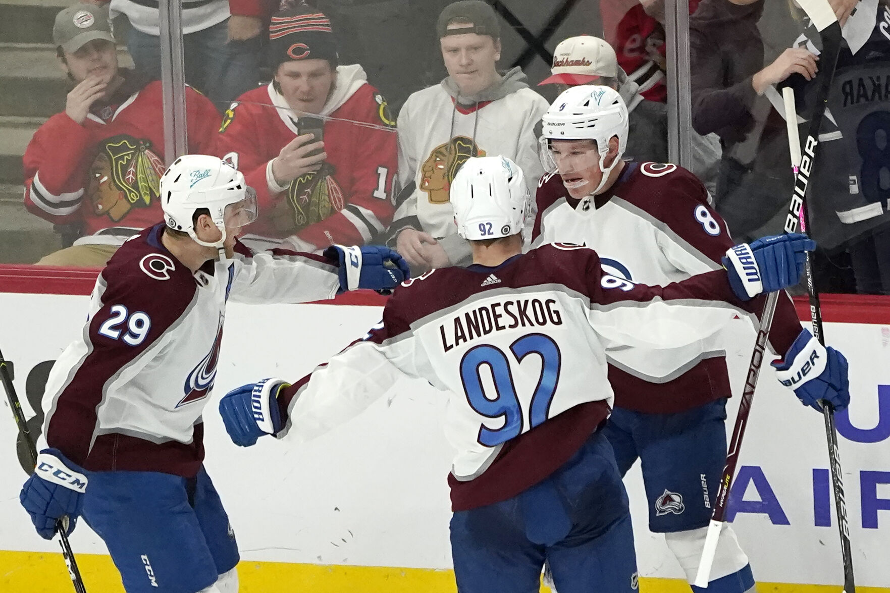 Colorado Avalanche's Cale Makar (8) celebrates his game winning goal with Nathan MacKinnon (29) and Gabriel Landeskog during the overtime period of an NHL hockey game against the Chicago Blackhawks Tuesday, Jan. 4, 2022, in Chicago. The Avalanche won 4-3. (AP Photo/Charles Rex Arbogast) (Charles Rex Arbogast)