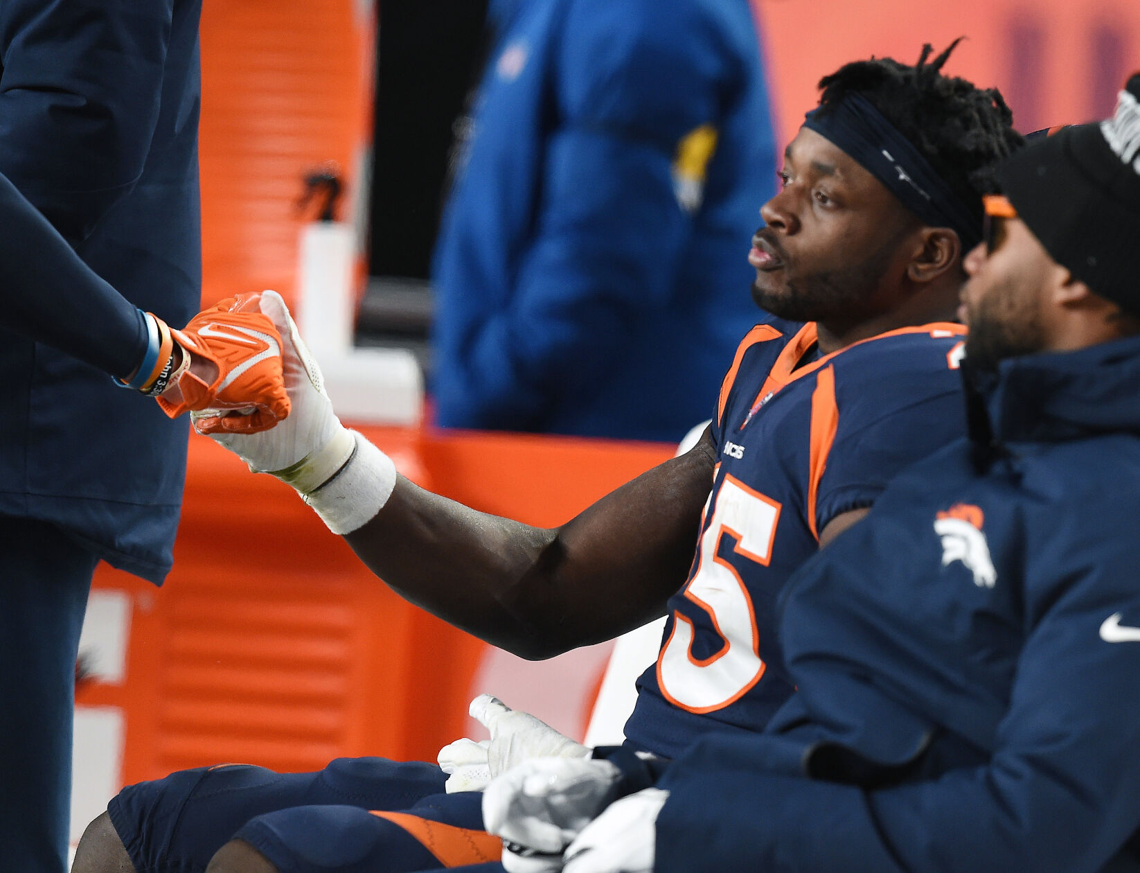 Broncos running back Melvin Gordon III sits on the bench after fumbling the ball in the 4th quarter. He was getting a comforting handshake from a teammate in a lost to the Chiefs on Saturday at Empower Field at Mile High Stadium. (Jerilee Bennett, The Gazette)