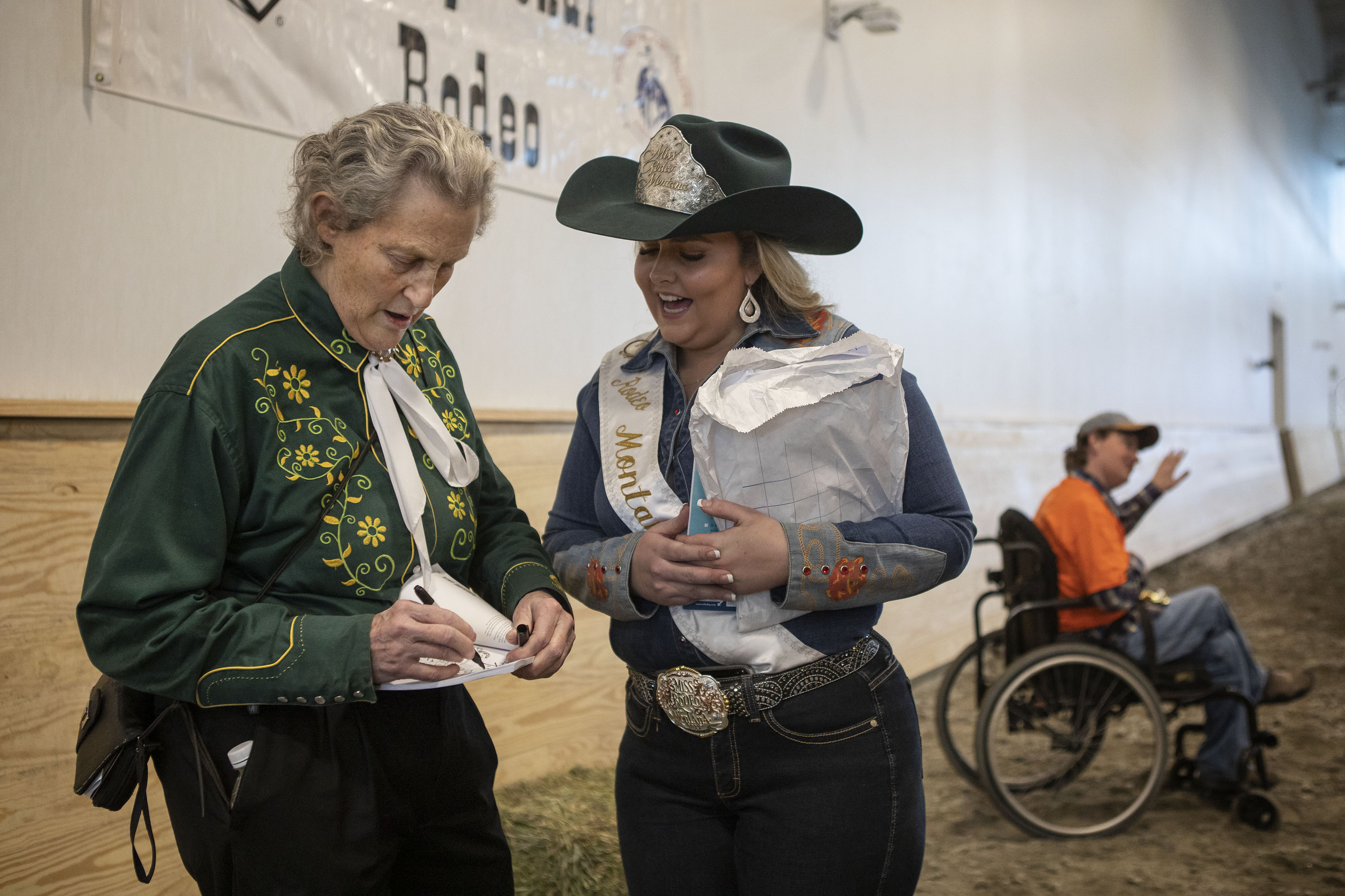 Temple Grandin signs a copy of a book for Miss Rodeo Montana Briann Grimshaw during the Exceptional Rodeo at the Temple Grandin Equine Center on Thursday, Jan. 20, 2022, at the CSU Spur Campus in Denver, Colo. (Timothy Hurst/The Gazette) (Timothy Hurst)