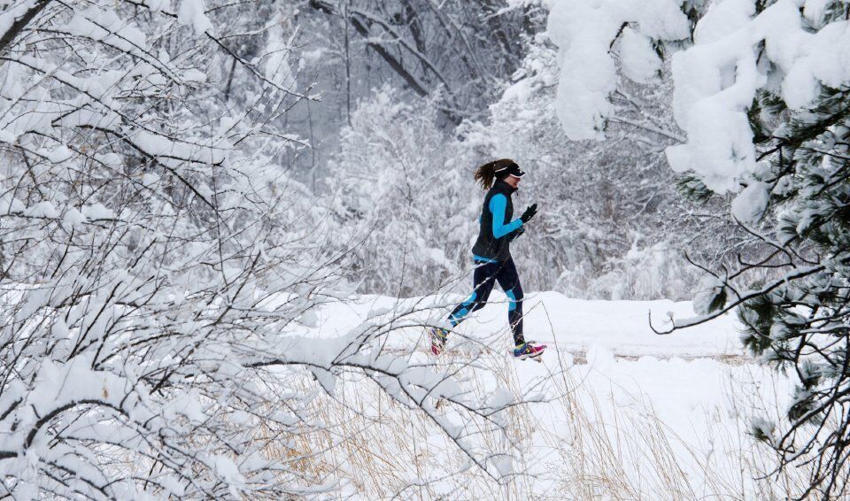 A runner jogs through a winter wonderland in Monument Valley Park. (The Gazette, Christian Murdock) (CHRISTIAN MURDOCK, THE GAZETTE)