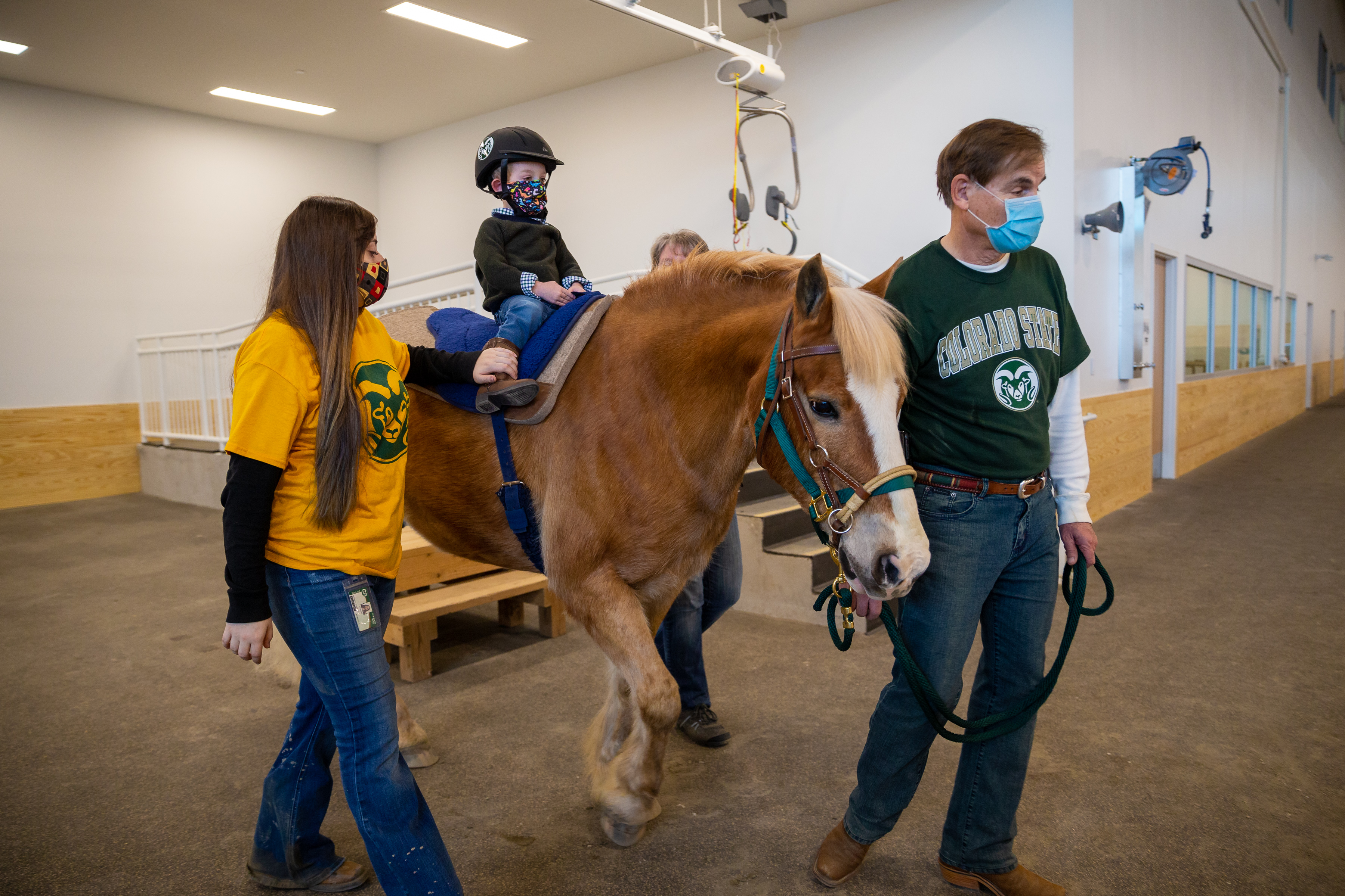 Four-year-old Rhys Robertson-Delaguardia engages in equine therapy with Adel the horse at the Temple Grandin Equine Center inside the Vida Building on the Colorado State University Spur campus on Friday, Jan. 7, 2022, in Denver, Colo. (Liz Copan / special to The Denver Gazette) (Liz Copan)