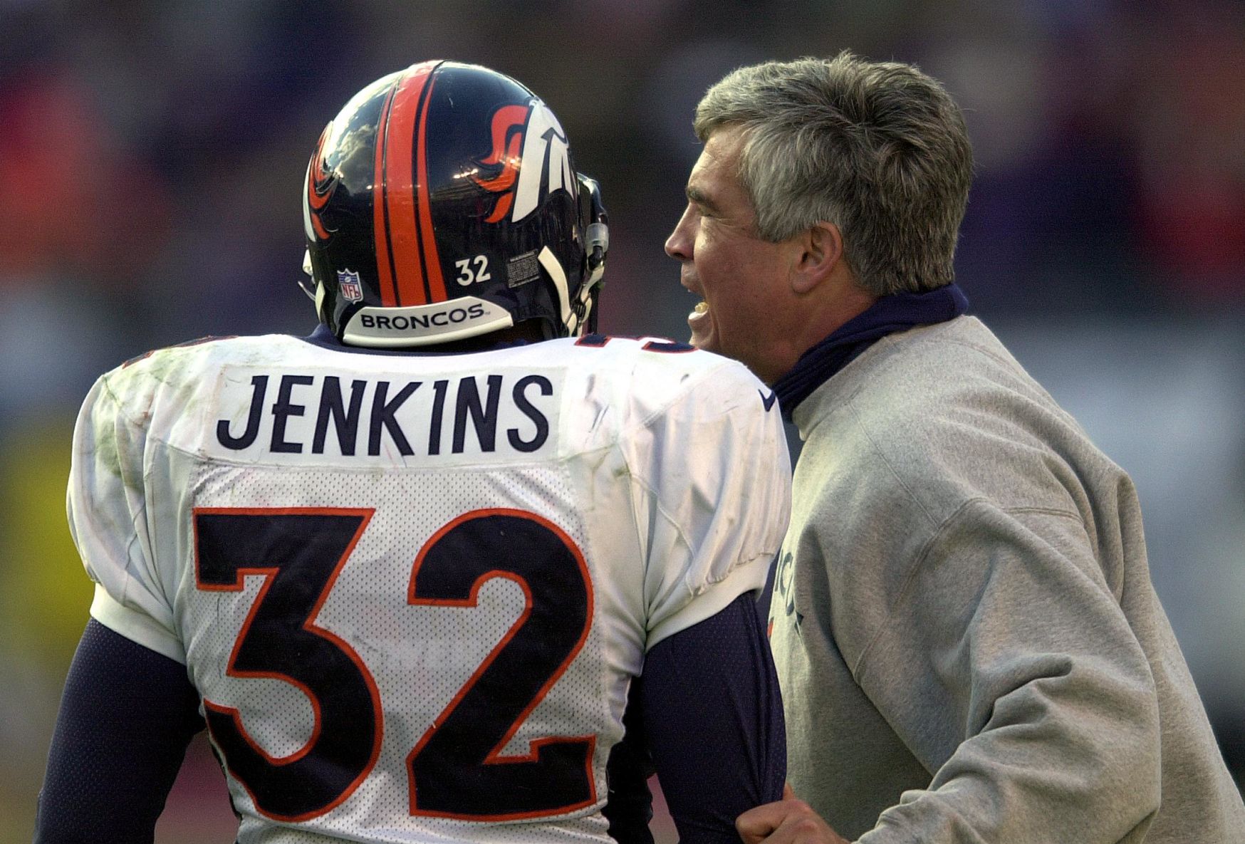Broncos defensive coordinator Greg Robinson gives instructions to safety Billy Jenkins in the fourth quarter of Denver’s 21-3 loss to Baltimore Sunday at PSINet Stadium. Reis photo (Mark Reis)