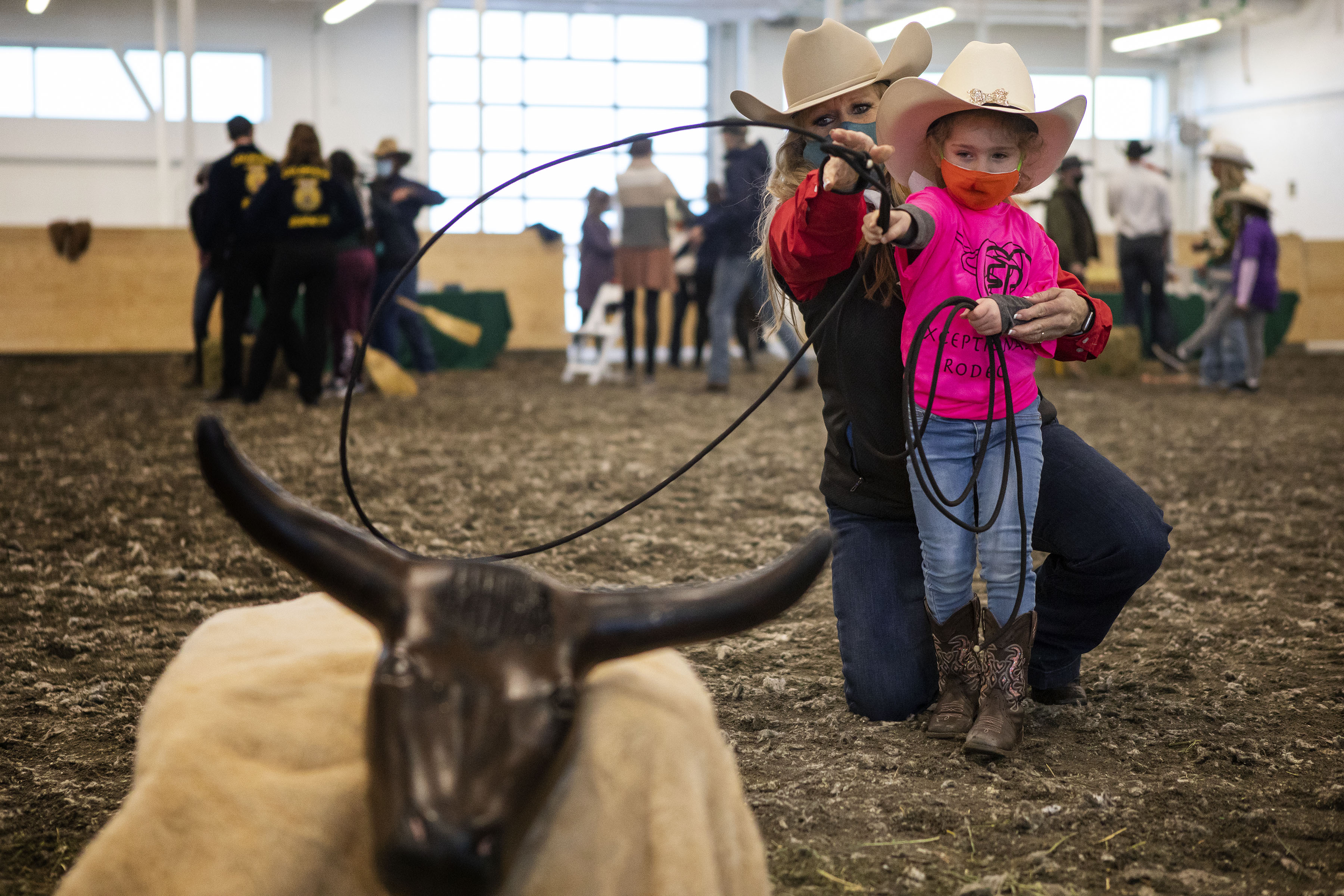 Harper Miller, 4, gets some instruction on calf roping from Colorado Stars & Stripes, Co. member Michelle Martin during the Exceptional Rodeo in the Temple Grandin Equine Center on Thursday, Jan. 20, 2022, at the CSU Spur Campus in Denver, Colo. (Timothy Hurst/The Gazette) (Timothy Hurst)