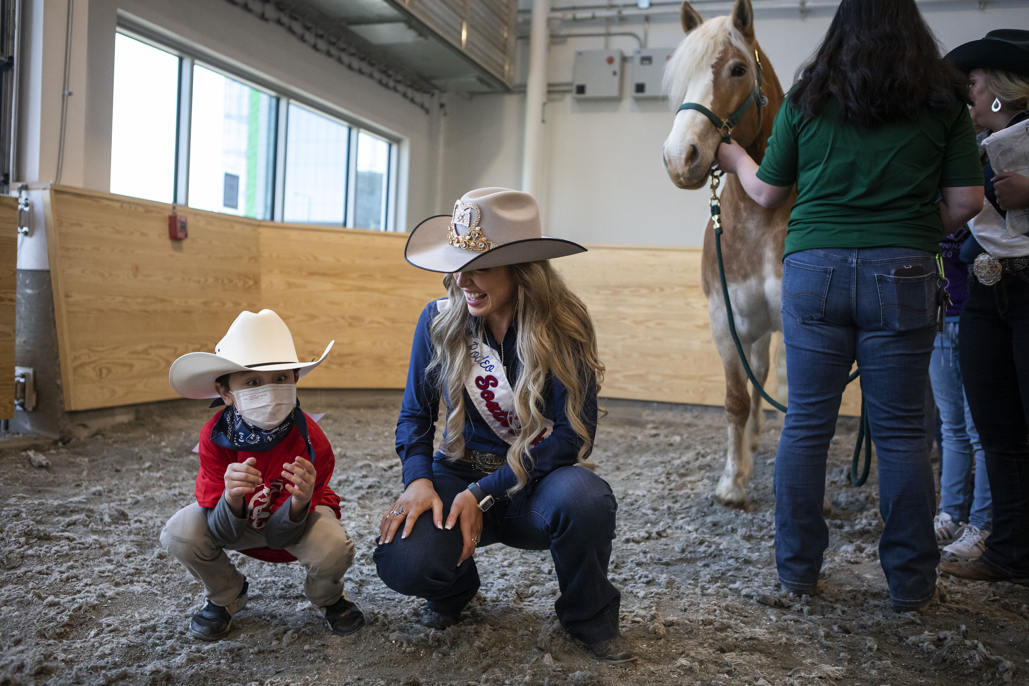Second grader RyLeigh Vigil, 7, cracks up Miss Rodeo South Dakota Adrianne Schaunaman as they participate in the Exceptional Rodeo in the Temple Grandin Equine Center on Thursday, Jan. 20, 2022, at the CSU Spur Campus in Denver, Colo. (Timothy Hurst/The Gazette) (Timothy Hurst)