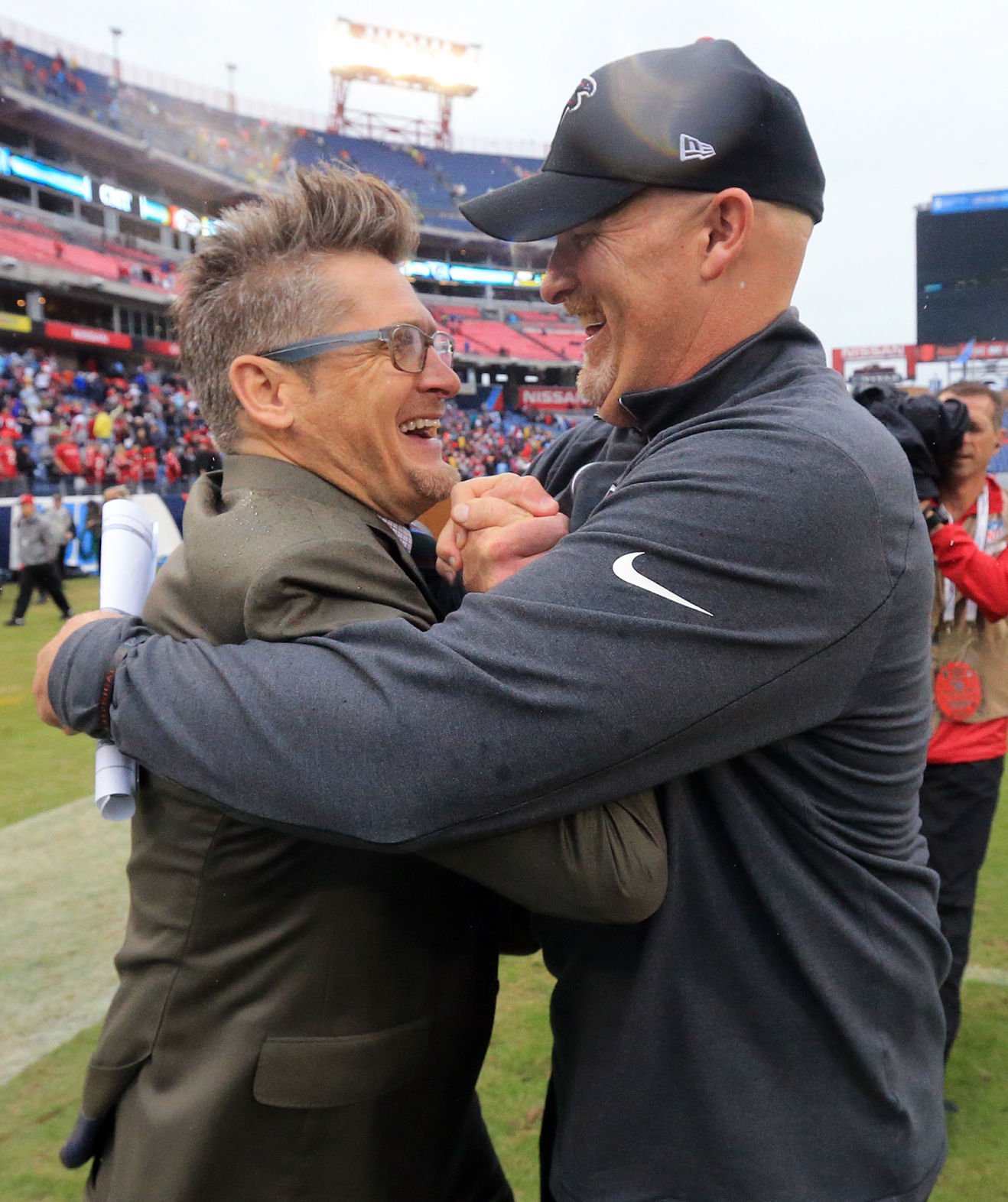 Falcons general manager Thomas Dimitroff, left, and head coach Dan Quinn celebrate after beating the Titans 10-7 in a football game on Sunday, Oct. 25, 2015, in Nashville. (Curtis Compton/Atlanta Journal-Constitution via AP) (Curtis Compton)