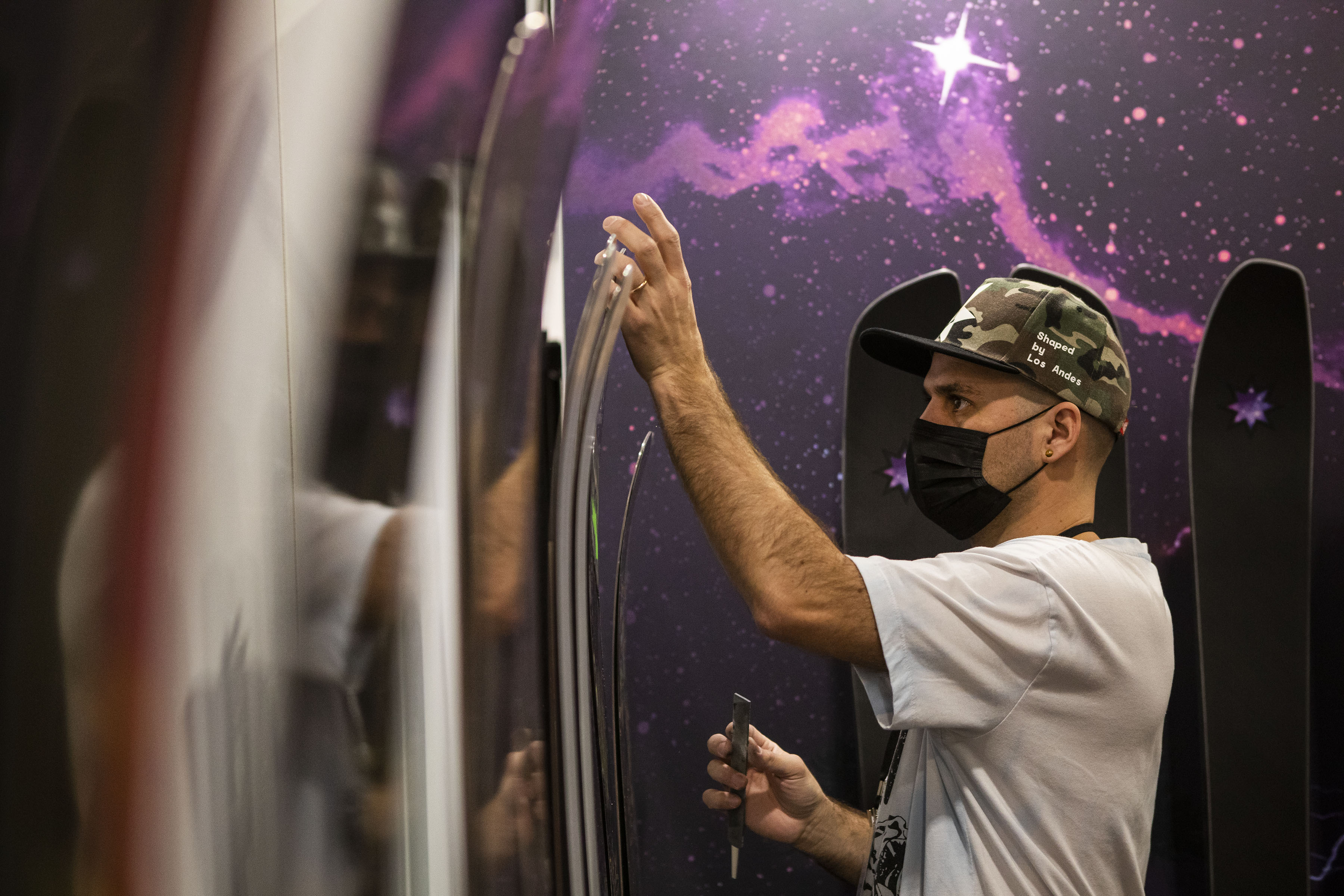 Juan Ignacio Tejeda with Chilean company Awka Skis, carefully cleans a row of skis during the second day of the Outdoor Retailer Snow Show at the Colorado Convention Center on Thursday, Jan. 27, 2022, in Denver, Colo. (Timothy Hurst/The Gazette) (Timothy Hurst/The Denver Gazette)