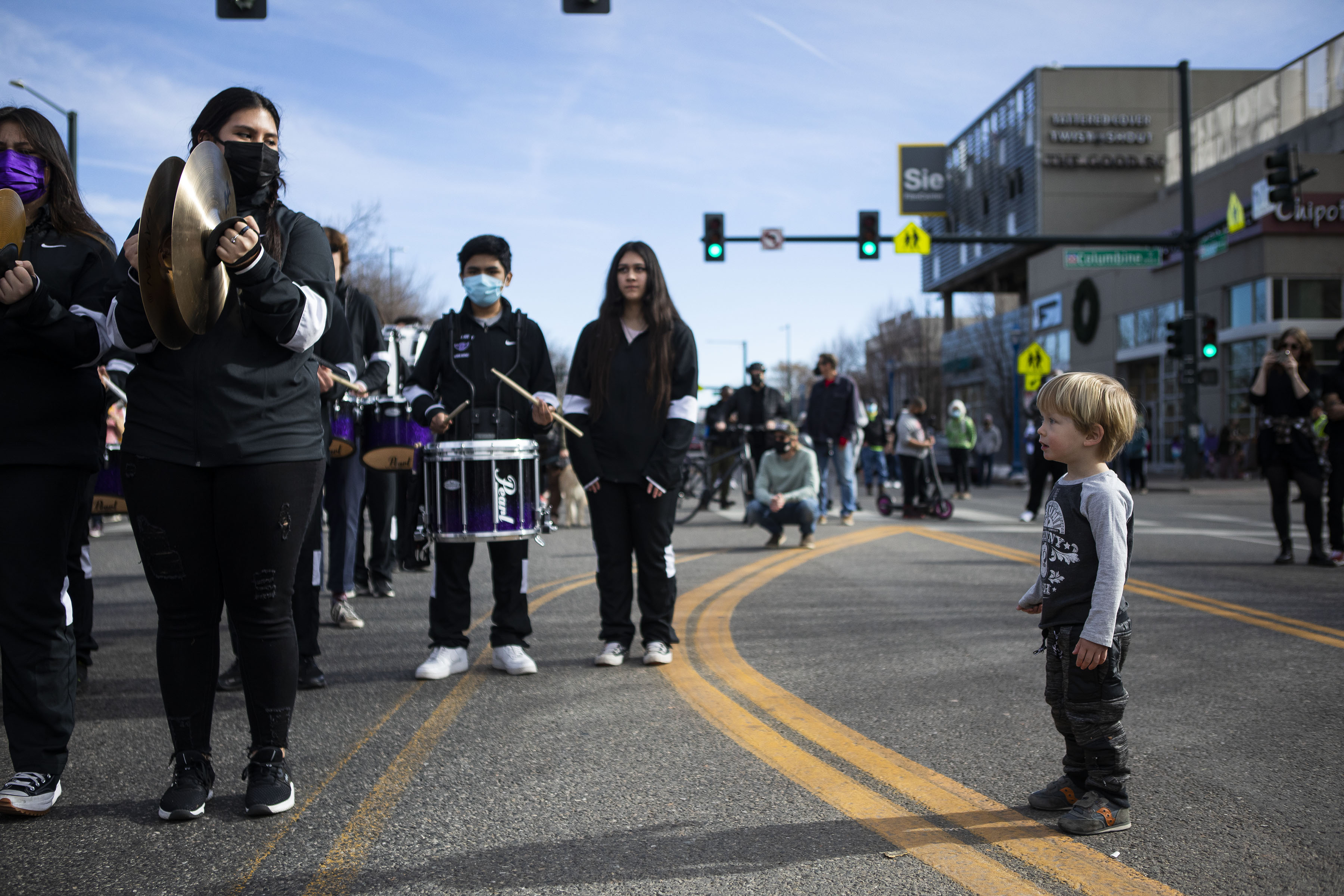 Van Collum, 3, is infatuated by a marching band drum corp during the Martin Luther King Marade on Monday, Jan. 17, 2022, in Denver, Colo. (Timothy Hurst/The Gazette) (Timothy Hurst)