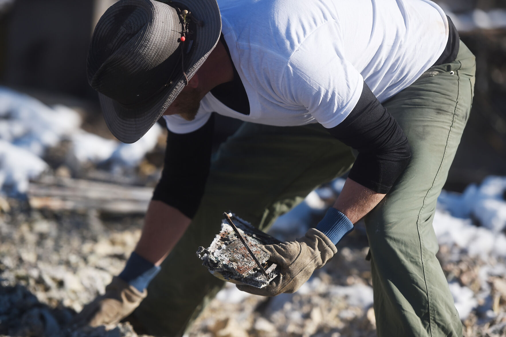 Rob Harris finds what he believes is the hard drive to his computer in the rubble of his home on Sunday, Jan. 2, 2022. Harris lost everything when his home burned during the Marshall Fire on Thursday night. He was clearing the rubble and was hoping to find the arrowheads that his father and he had collected. Harris said he and his wife are going to rebuild. (Photo by Jerilee Bennett, The Gazette) (Jerilee Bennett)