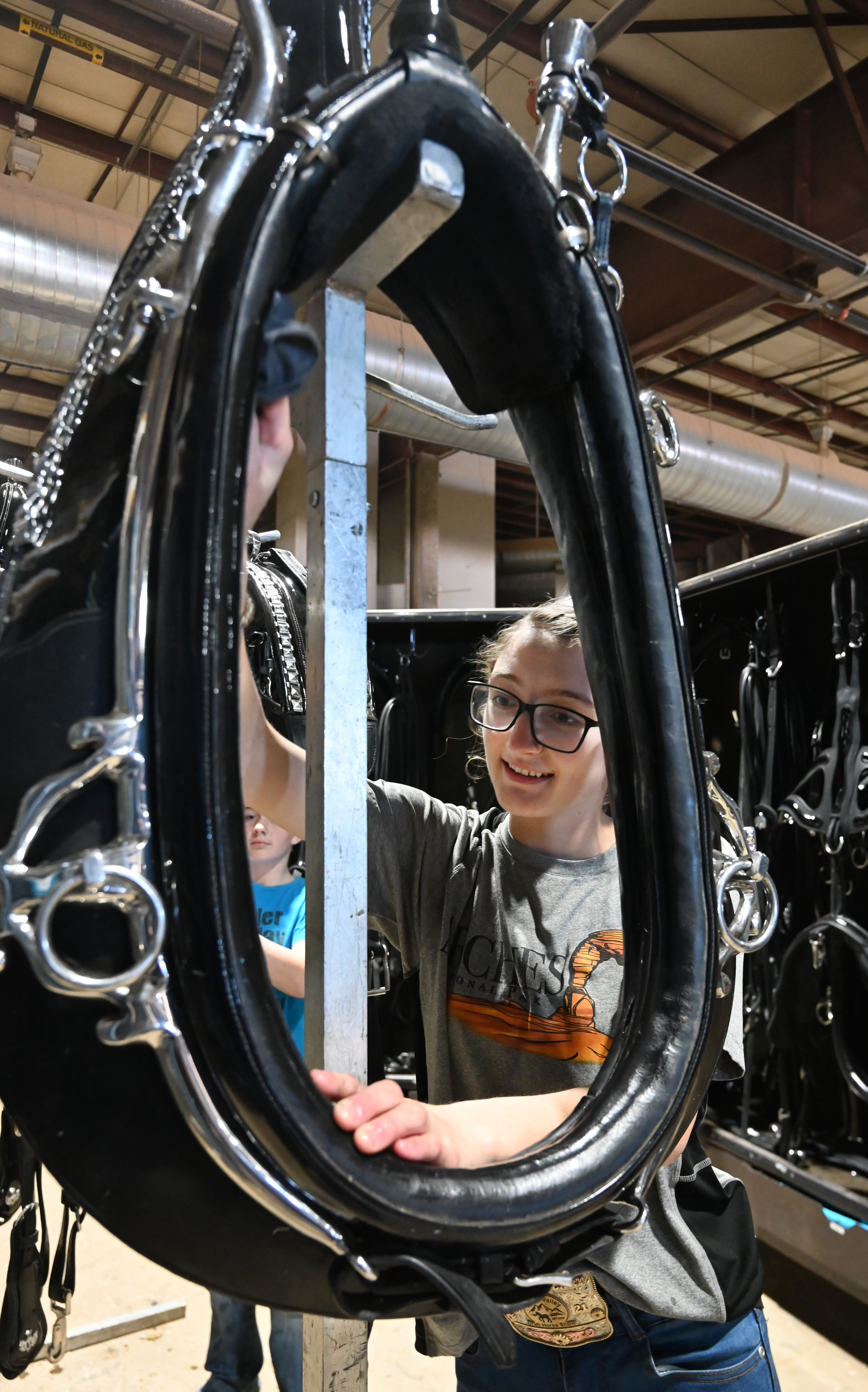 Wanda Yoder shines up a harness after the draft horse show before packing it away. Sunday was the last, but not the least day of the National Western Stock Show in Denver. The draft horse show made for a grand finale. Yoder’s family owns the team that represents the Yoder Family Hay Company in Westcliffe. (Photo by Jerilee Bennett, The Gazette) (Jerilee Bennett)