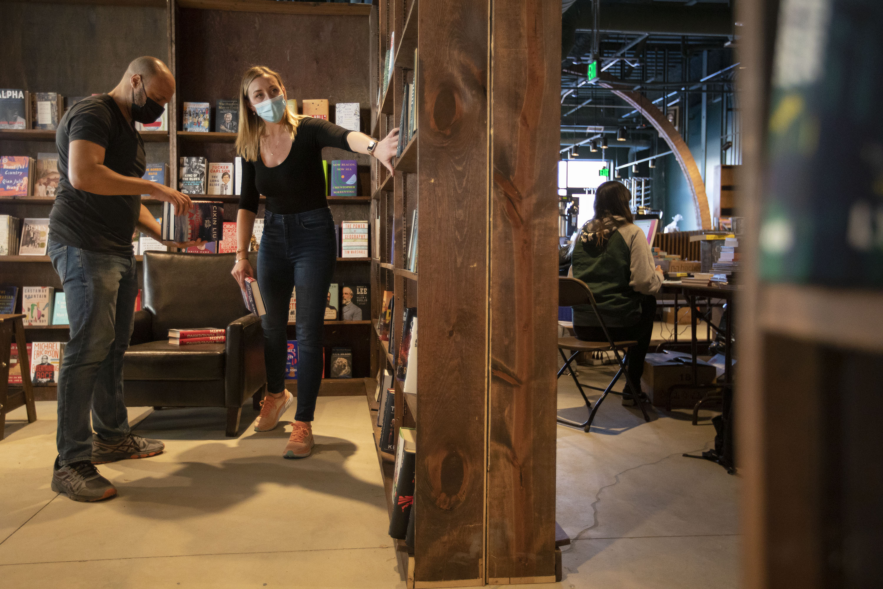 In this file photo, then-Tattered Cover Book Store CEO Kwame Spearman, left, and chief marketing officer Katherine Rainbolt stock the shelves of the new science section on Jan. 4, 2022 in preparation of the store opening its newest location in Westminster. (TimHursttim.hurst@gazette.comhttps://secure.gravatar.com/avatar/aca82bd62b4ee425c598527cd6faa1b1?d=mm&r=g)