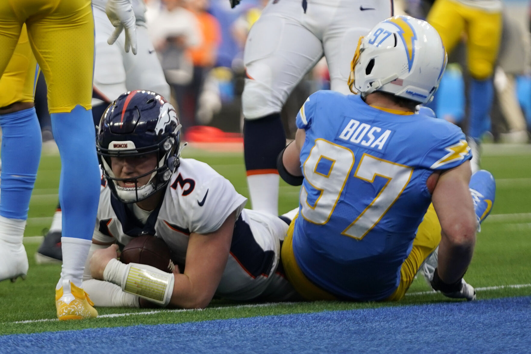 Denver Broncos quarterback Drew Lock (3) comes up short on 4th and goal next to Los Angeles Chargers defensive end Joey Bosa (97) during the first half of an NFL football game Sunday, Jan. 2, 2022, in Inglewood, Calif. (AP Photo/Ashley Landis)