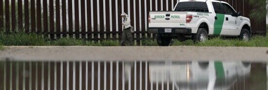A U.S. Customs and Border Patrol agent passes birdwatcher Nancy Hill, 81, along a section of the border wall Sunday, Nov. 13, 2016, in Hidago, Texas. (Eric Gay/AP)