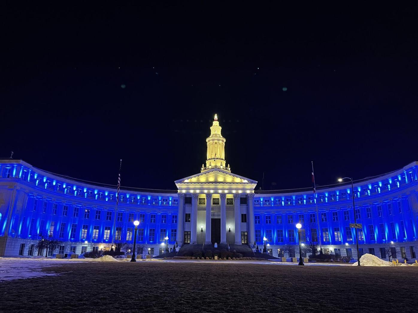 Denver City Hall is lit with the colors of Ukraine
