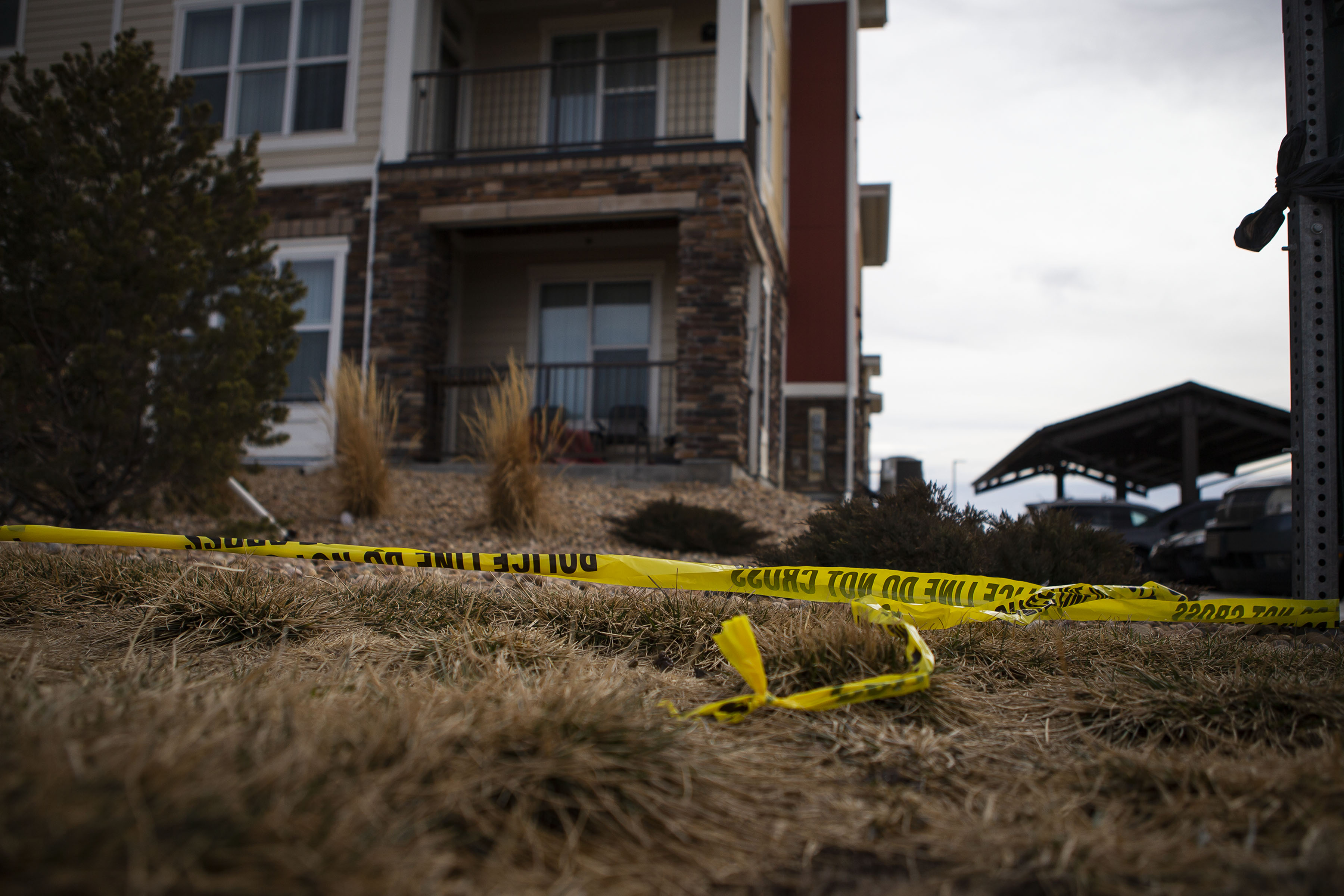 Police tape can be seen in front of an apartment building at 14480 East 104th Avenue where five people were found dead Sunday night, as seen on Monday, Feb. 21, 2022, in Commerce City, Colo. (Timothy Hurst/The Denver Gazette) (Timothy Hurst)
