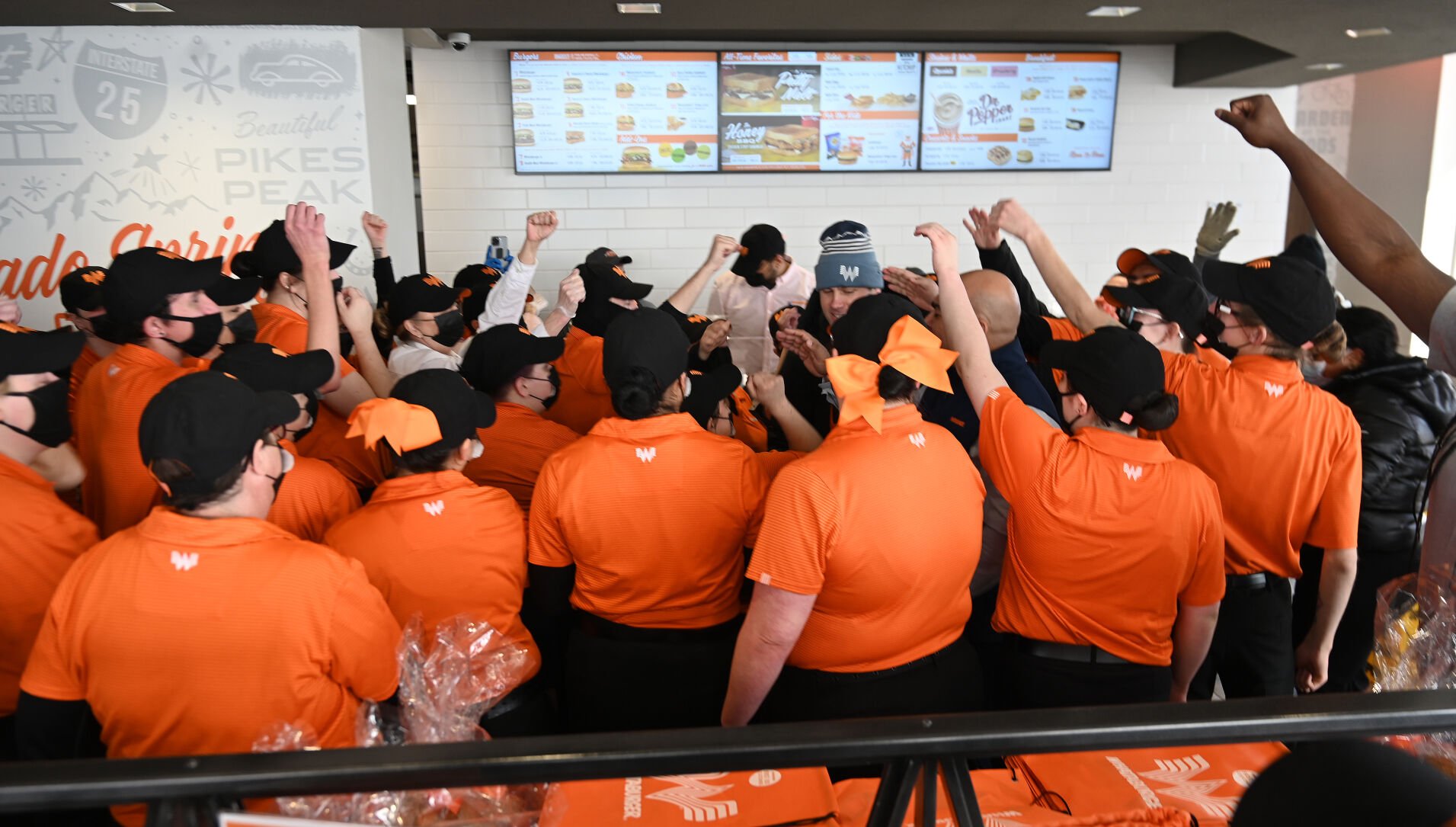 Minutes before opening, Whataburger employees rally for the first day on Wednesday, Feb. 23, 2022. This is the first Whataburger in Colorado since the chain left in the 1970’s. The chain is out of Texas and has a very loyal following. Hundreds waited both outside and in the drive through to be there for the first day. This is the only Whataburger in Colorado. (Photo by Jerilee Bennett, The Gazette)