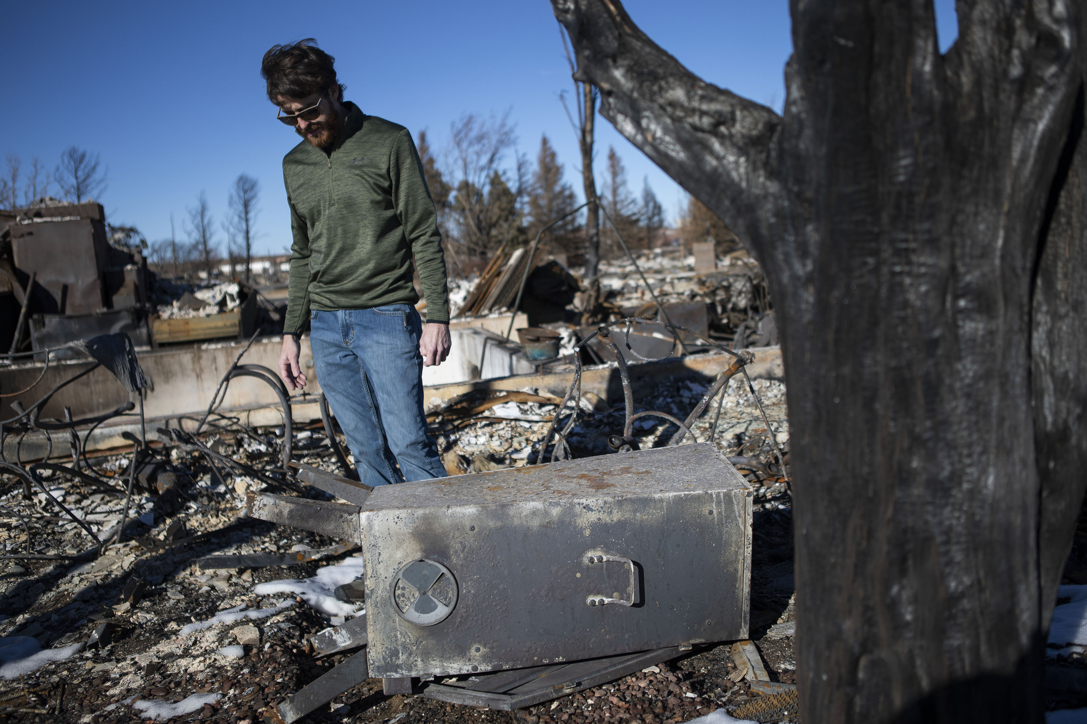 Wayne Shelnutt, the owner of Wayne's Smoke Shack, looks at the first smoker he had ever owned while surveying the charred remains of his home on Monday, Jan. 31, 2022, in Superior, Colo. (Timothy Hurst/The Denver Gazette) (Timothy Hurst/The Denver Gazette)