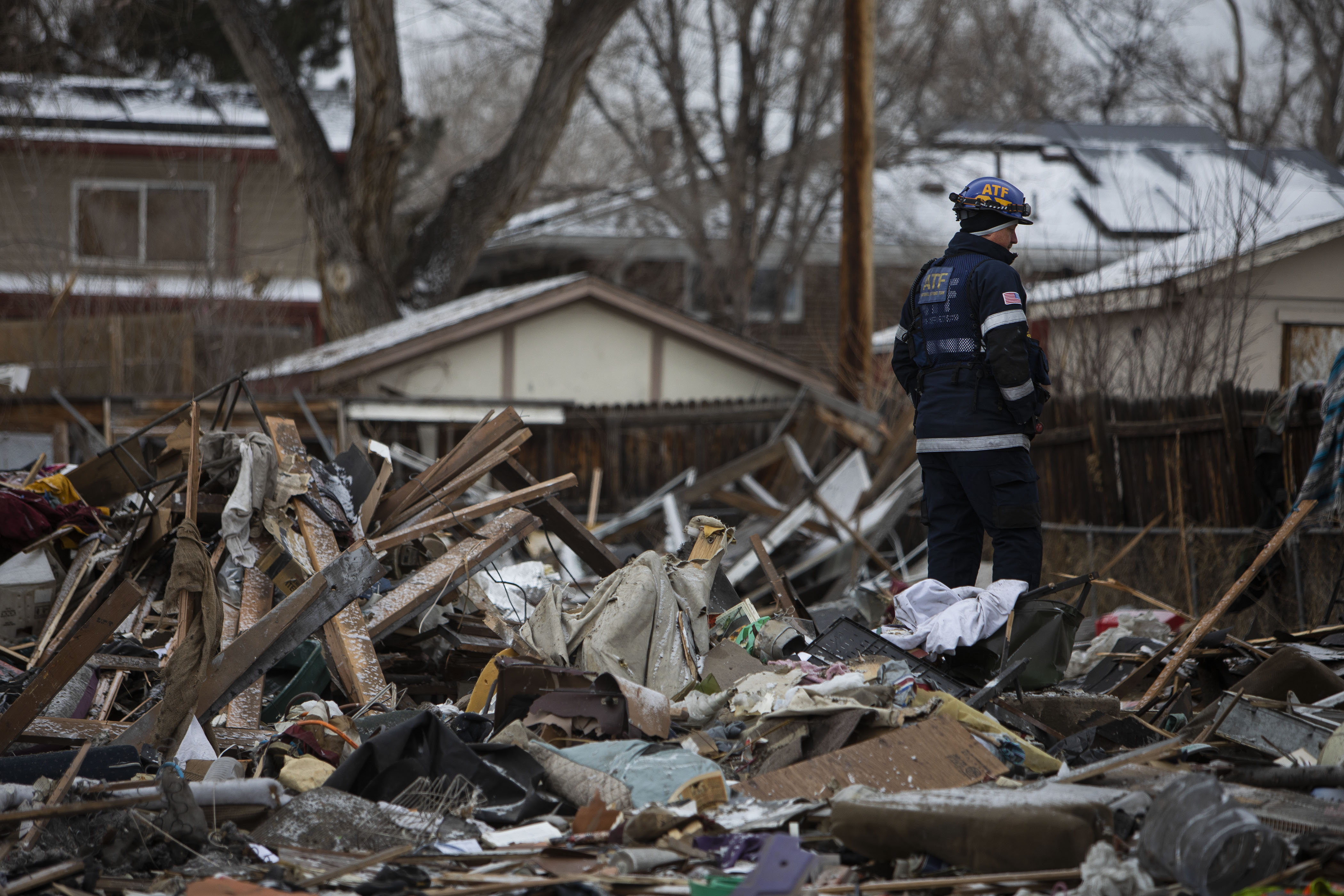A person in a Bureau of Alcohol, Tobacco, Firearms uniform looks over the rubble of a home that exploded on the 7700 block of Knox Court in the early hours of Tuesday, Feb. 22, 2022, in Westminster, Colo. (Timothy Hurst/The Denver Gazette) (Timothy Hurst)
