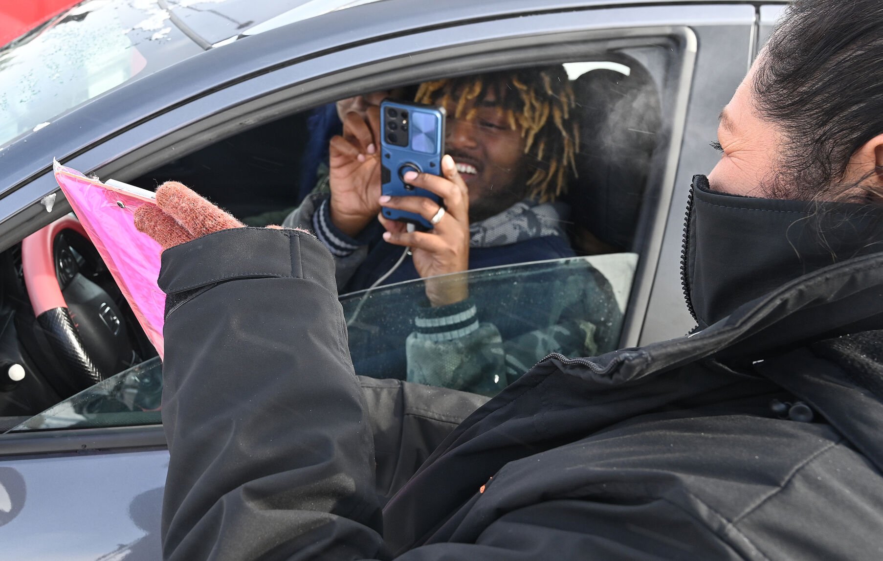 Whatburger enthusiast Blue Traylor scans the code of the new Whataburger to be able to order while in a long line of vehicles queued up to go through the drive-thru of the new Whataburger on Wednesday, Feb. 23, 2022. This is the first Whataburger in Colorado since the chain left in the 1970’s. The chain is out of Texas and has a very loyal following. Hundreds waited both outside and in the drive through to be there for the first day. This is the only Whataburger in Colorado. (Photo by Jerilee Bennett, The Gazette)