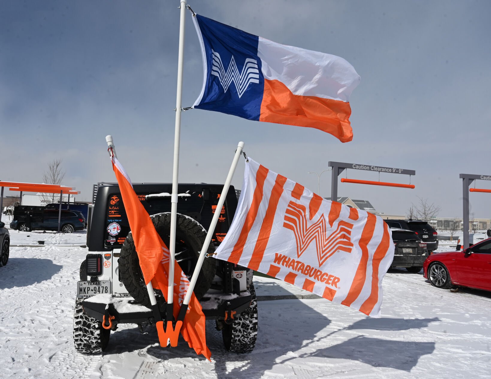 A Whataburger enthusiast waits in the long line of vehicles queued up to go through the drive-thru of the new Whataburger on Wednesday, Feb. 23, 2022. This is the first Whataburger in Colorado since the chain left in the 1970’s. The chain is out of Texas and has a very loyal following. Hundreds waited both outside and in the drive through to be there for the first day. This is the only Whataburger in Colorado. (Photo by Jerilee Bennett, The Gazette)