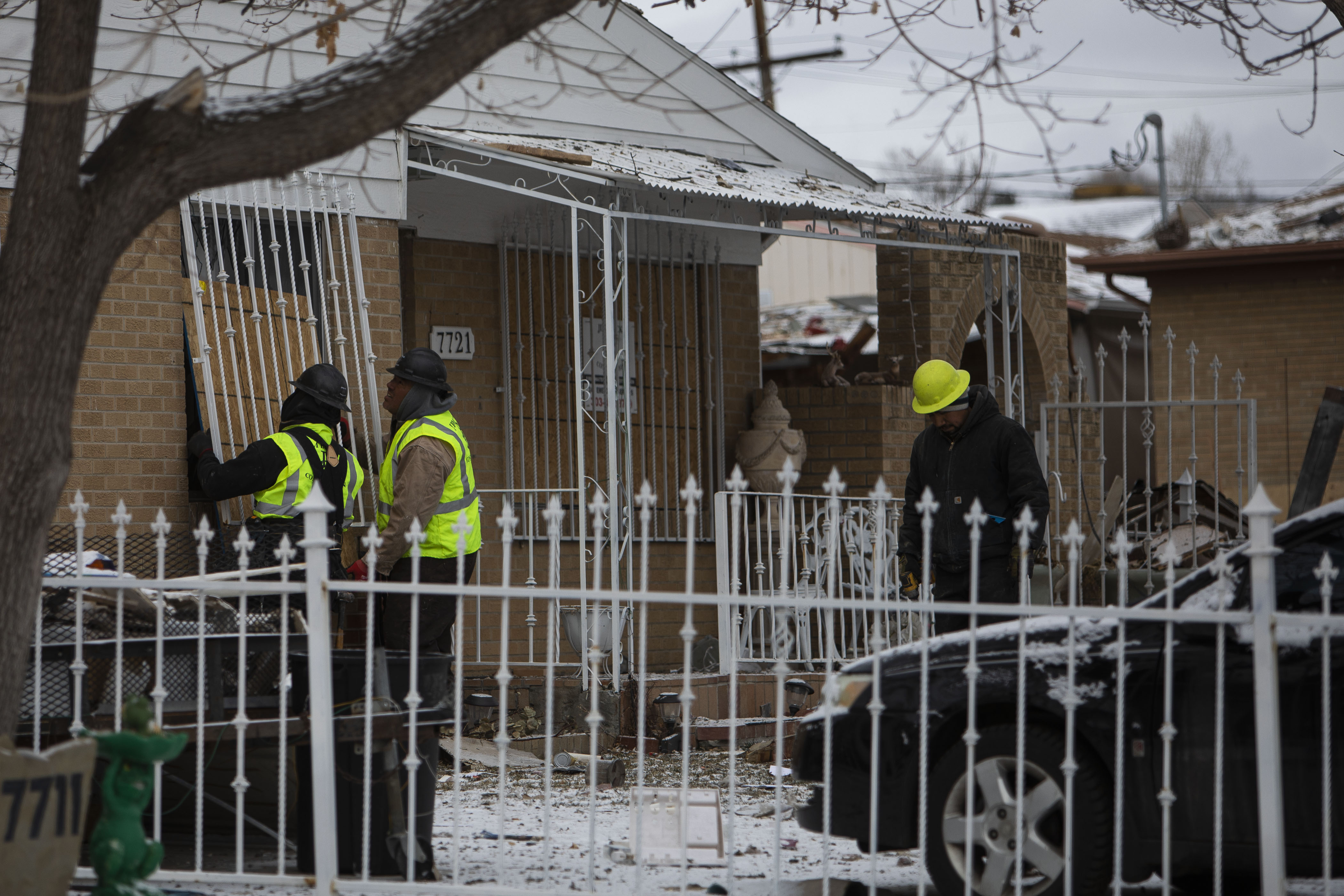 Crews place wood over the windows of a home next to another home that exploded on the 7700 block of Knox Court on Tuesday, Feb. 22, 2022, in Westminster, Colo. (Timothy Hurst/The Denver Gazette) (Timothy Hurst)