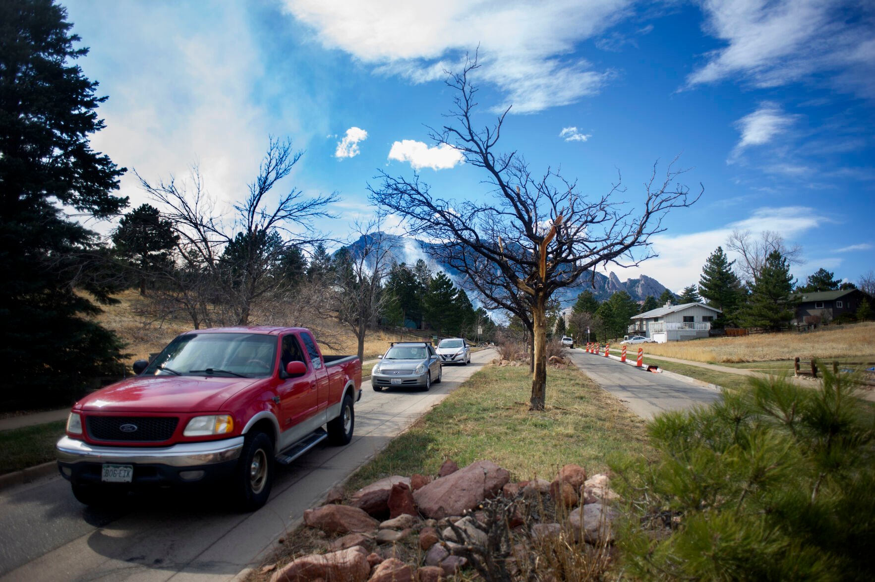 Evacuating individuals leave the Shanahan Ridge area as they flee from the NCAR Fire on March 26, 2022, in Boulder, Colo. (Jacob Byk/For The Denver Gazette)