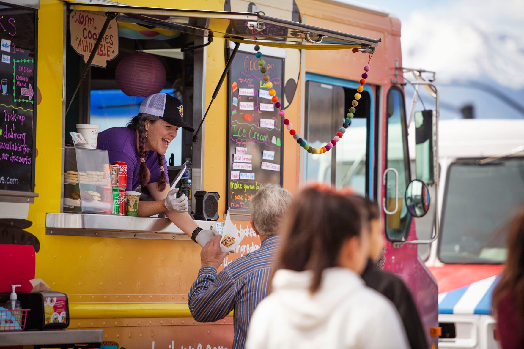 Clayton and Madonna Ranck order a sweet treat from Lori Morrissey’s food truck, Lori Lynn’s Cookies & Cream, during the 719 Food Truck Fest near Woodman Road in northeast Colorado Springs on Saturday, March 26, 2022. Morrissey features made-to-order ice cream sandwiches with her cookie made-from-scratch family recipes. (Chancey Bush/ The Gazette) (Chancey Bush/ The Gazette)