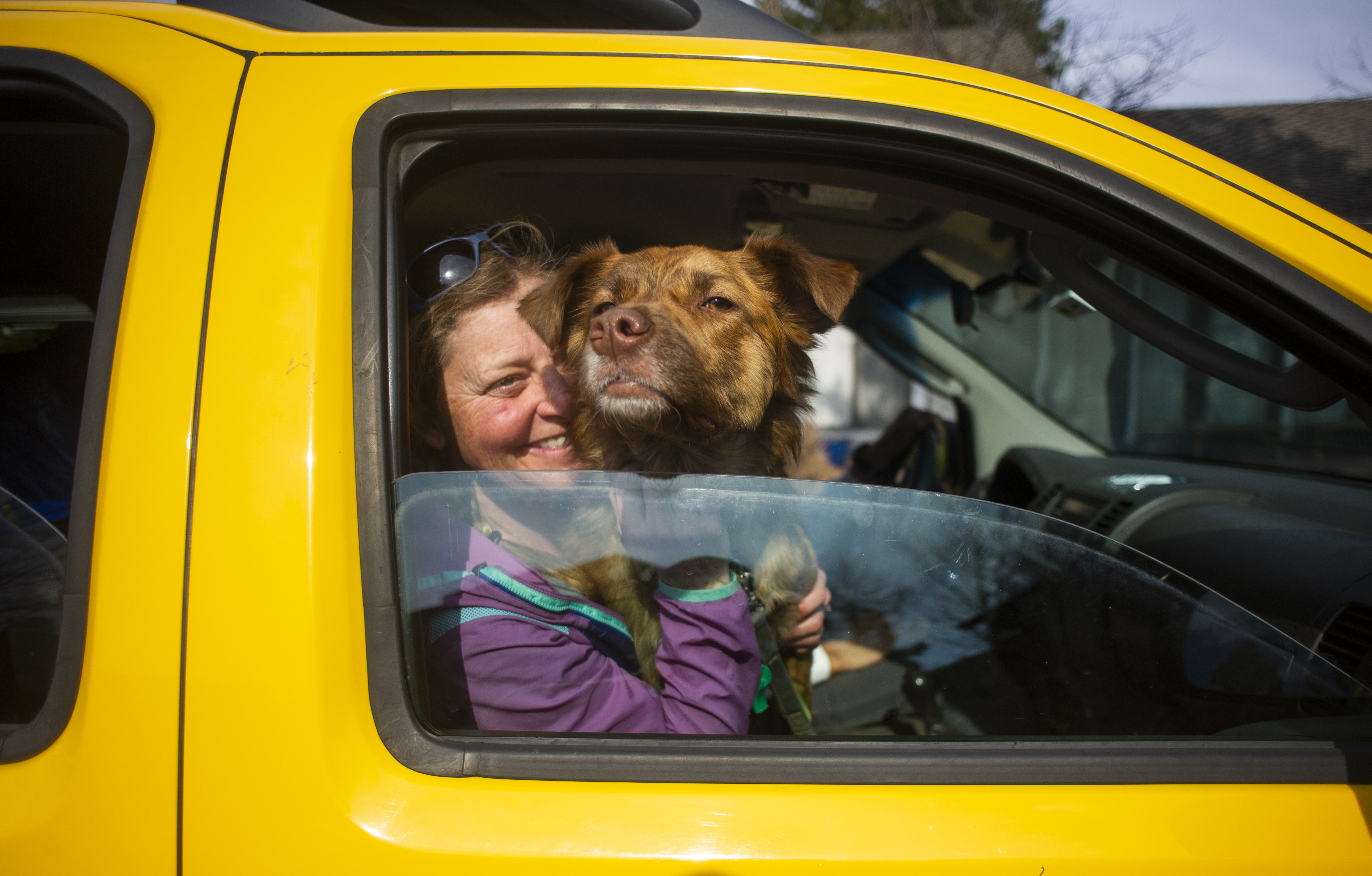 Wendy Drake shares a moment with one of her tenant's animals, Harper, whom she rescued, before evacuating the NCAR Fire on March 26, 2022, in Boulder, Colo. (Jake Byk/For the Denver Gazette)