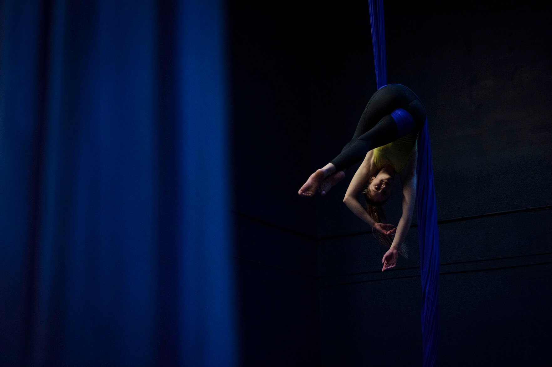 Adalyn Brown, 12, is suspended in the air by silk fabric as she practices her technique during a teen intermediate aerial silk class at the Urban Cirque studio in Colorado Springs on Tuesday, March 15, 2022. Owner Katrina Diaz opened her studio in January, where she shares her passion of circus-style fitness with teens and adults, teaching the art of silks, hoops and aerial fitness ranging from beginner to intermediate classes. (Chancey Bush /The Gazette) (Chancey Bush/ The Gazette)