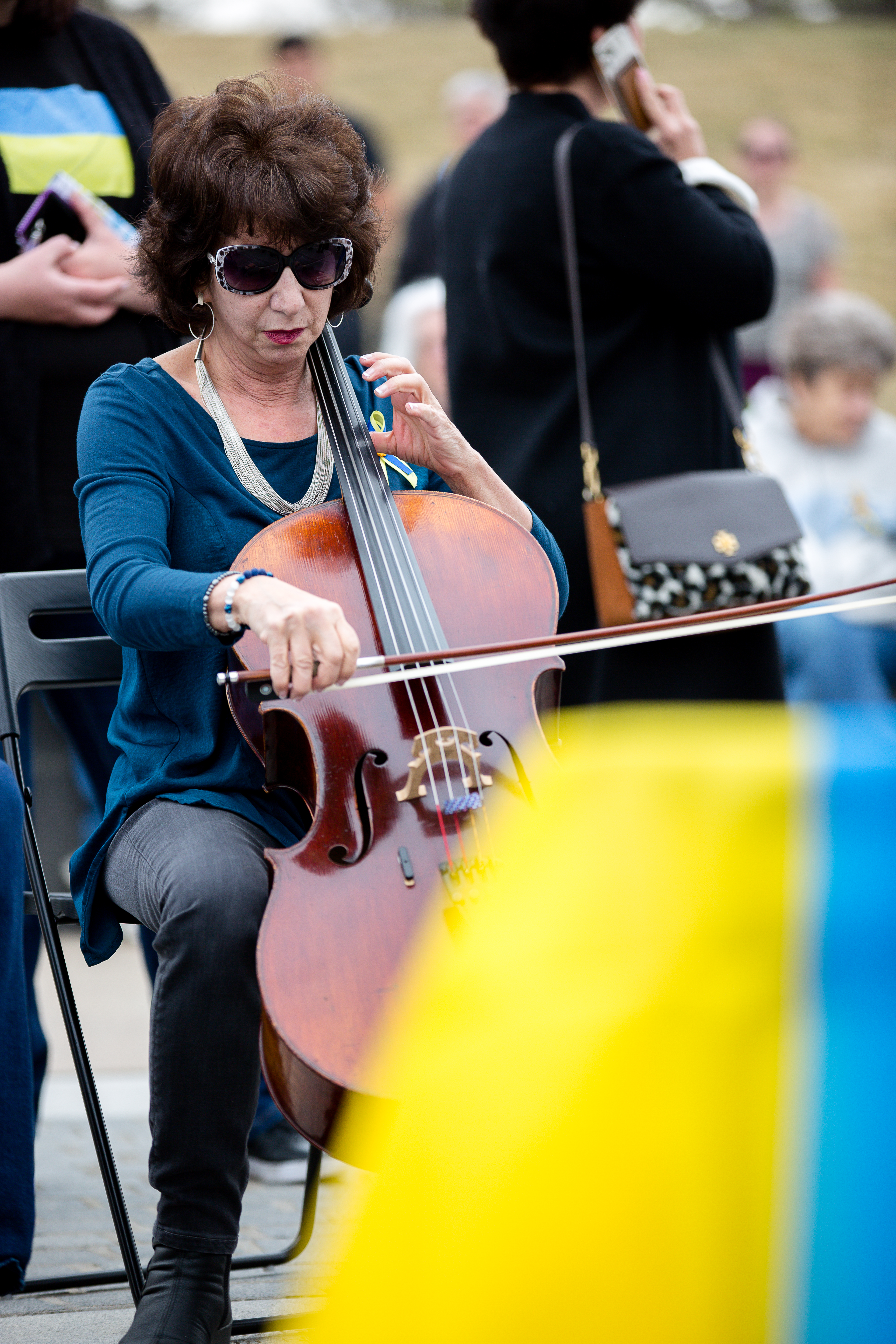 Andrea Meyers was on her way to practice when she made the decision to lend her support, and cello, to the Gathering for Peace and in Support of the Ukrainian People event at Babi Yar Park, Sunday, March 27. ((Sara Hertwig/for The Denver Gazette))