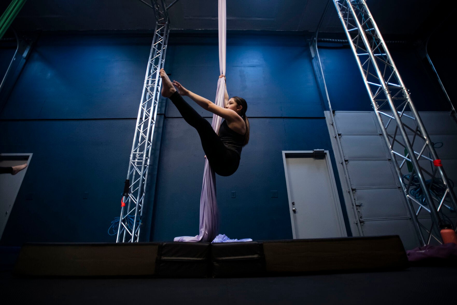 Brianna Mix, 13, practices techniques during a teen intermediate aerial silk class at the Urban Cirque studio in Colorado Springs on Tuesday, March 15, 2022. Owner Katrina Diaz opened her studio in January, where she shares her passion of circus-style fitness with teens and adults, teaching the art of silks, hoops and aerial fitness ranging from beginner to intermediate classes. (Chancey Bush /The Gazette) (Chancey Bush/ The Gazette)