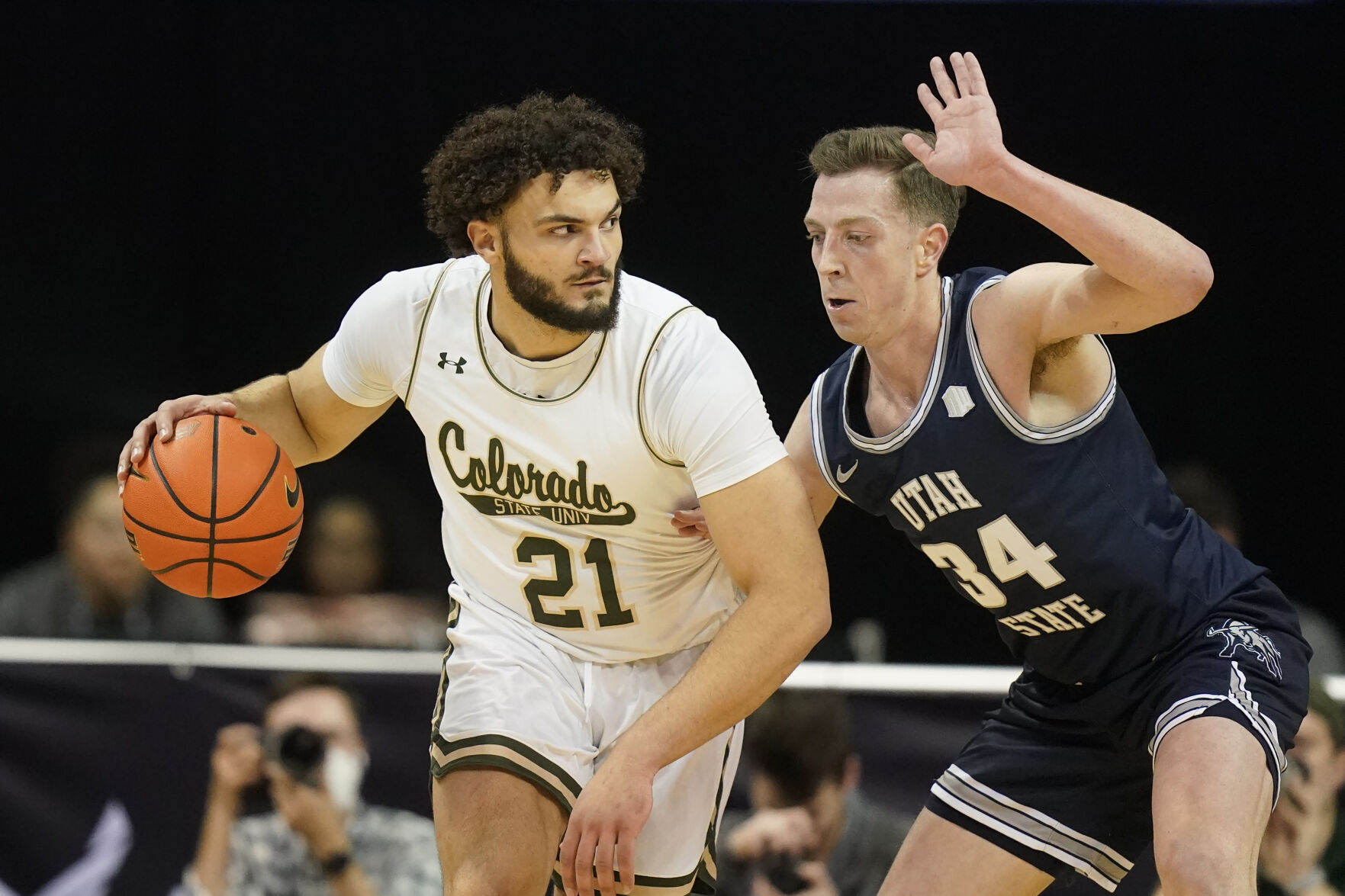 Utah State forward Justin Bean (34) guards against Colorado State guard David Roddy (21) during the first half of an NCAA college basketball game in the quarterfinals of Mountain West Conference men's tournament Thursday in Las Vegas. (The Associated Press)