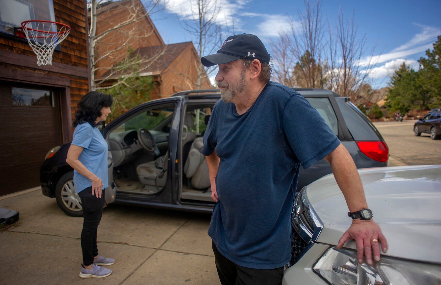 Steve Gimpel, who has been a resident of south Boulder since 1999, pauses, while he and his wife Bernadette (back) contemplate any other items they wish to evacuate, while fleeing the NCAR Fire on March 26, 2022, in Boulder, Colo. (Jacob Byk/ For The Denver Gazette)