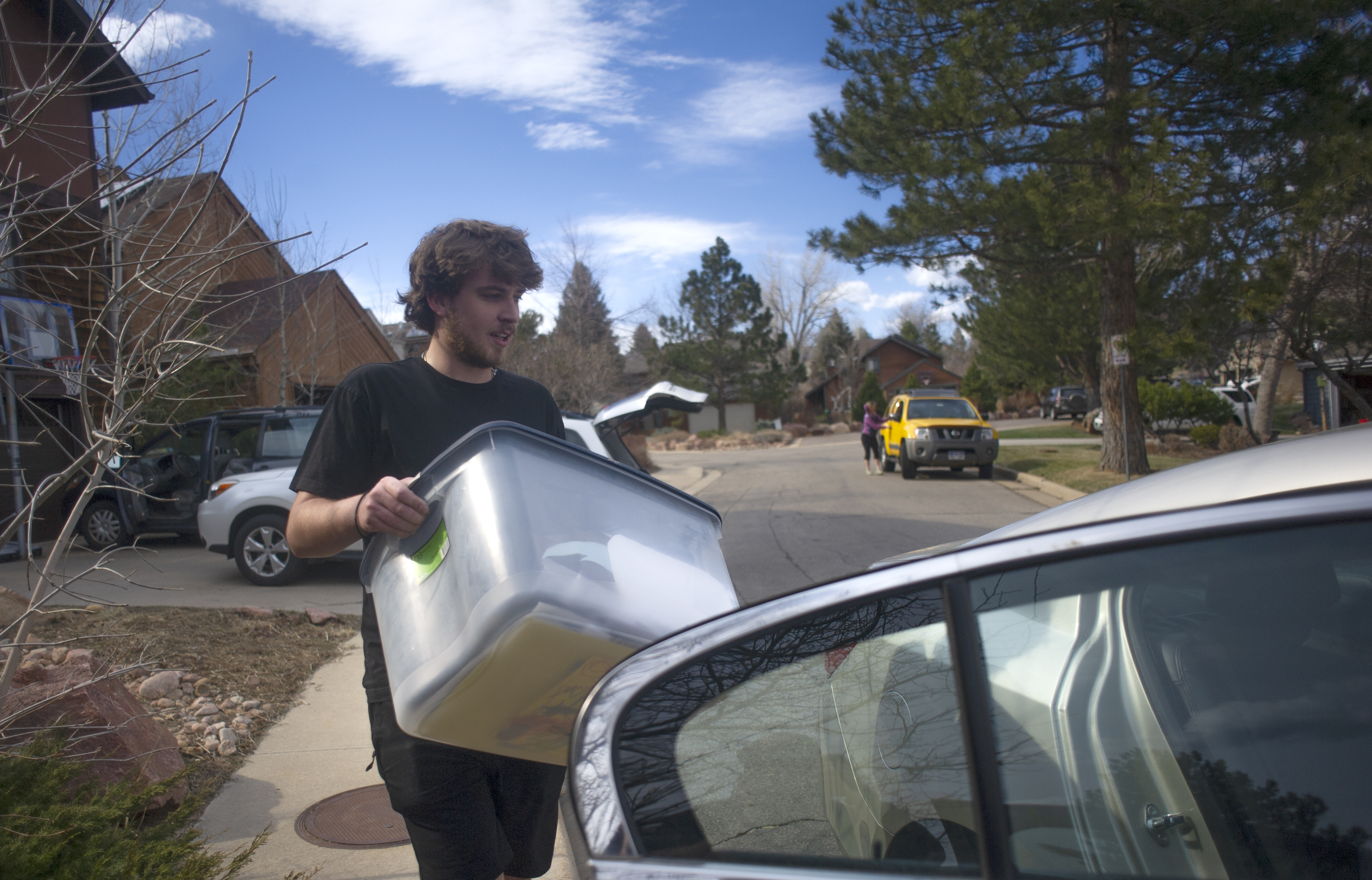 Fin Gimpel, 20, loads supplies into a vehicle before evacuating the NCAR Fire on March 26, 2022, in Boulder, Colo. (Jake Byk/For the Denver Gazette)
