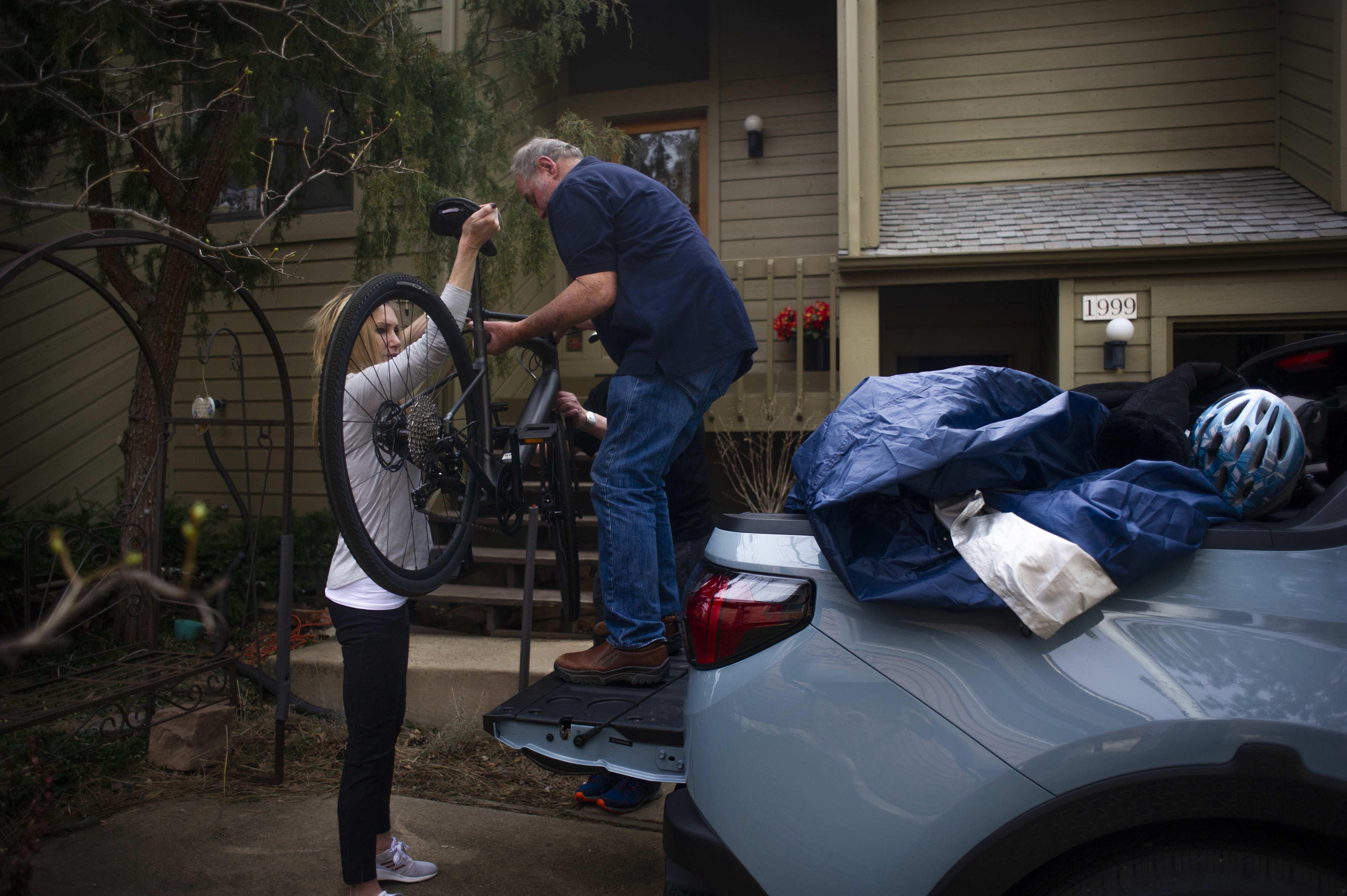 Kent Hogan, a 16-year-resident of south Boulder, receives help from neighbor Cindy Gross as he loads supplies into his vehicle before evacuating the NCAR Fire on March 26, 2022, in Boulder, Colo. (Jake Byk/For the Denver Gazette)