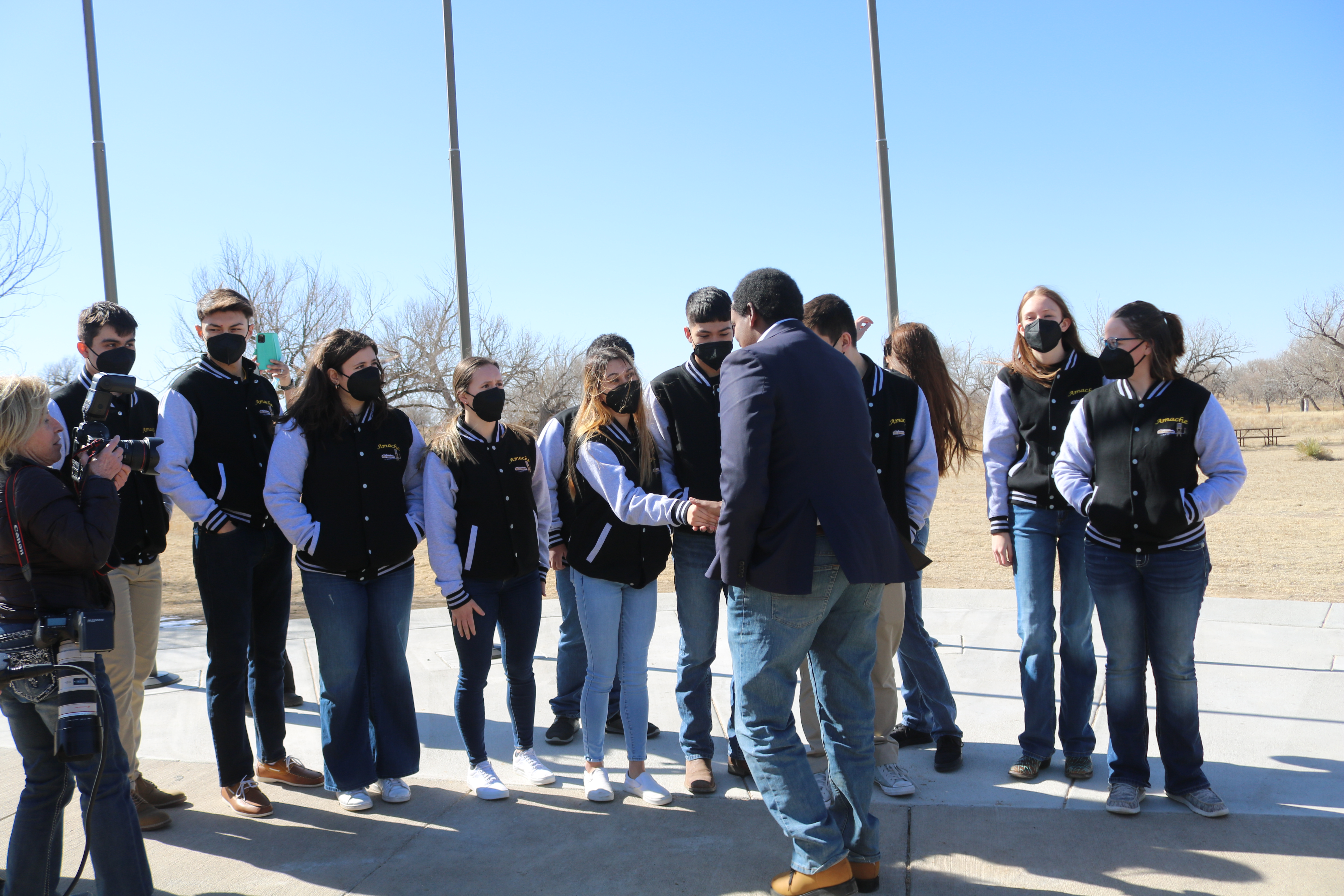 Granada High School students meet with U.S. Rep. Joe Neguse at the Day of Remembrance ceremony at Camp Amache in February. It was the 80th anniversary of the date President Franklin Roosevelt signed the executive order to forcibly relocate Japanese-Americans to internment camps after the attack on Pearl Harbor. (Courtesy of John Hopper)