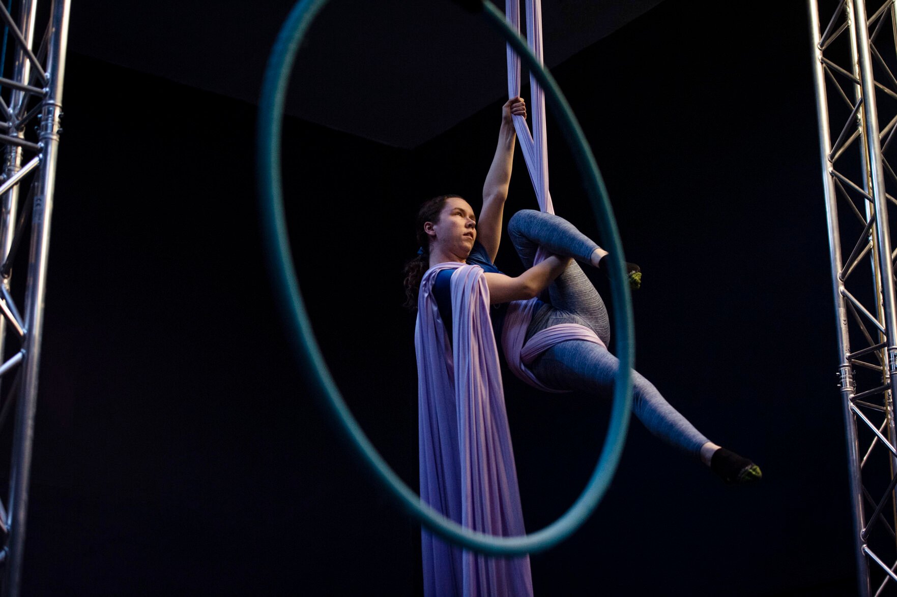 Olivia McCommons, 27, is suspended in the air by an aerial silk at Urban Cirque studio in Colorado Springs on Tuesday, March 15, 2022. Owner Katrina Diaz opened her studio in January, where she shares her passion of circus-style fitness with teens and adults, teaching the art of silks, hoops and aerial fitness ranging from beginner to intermediate classes. (Chancey Bush /The Gazette) (Chancey Bush/ The Gazette)