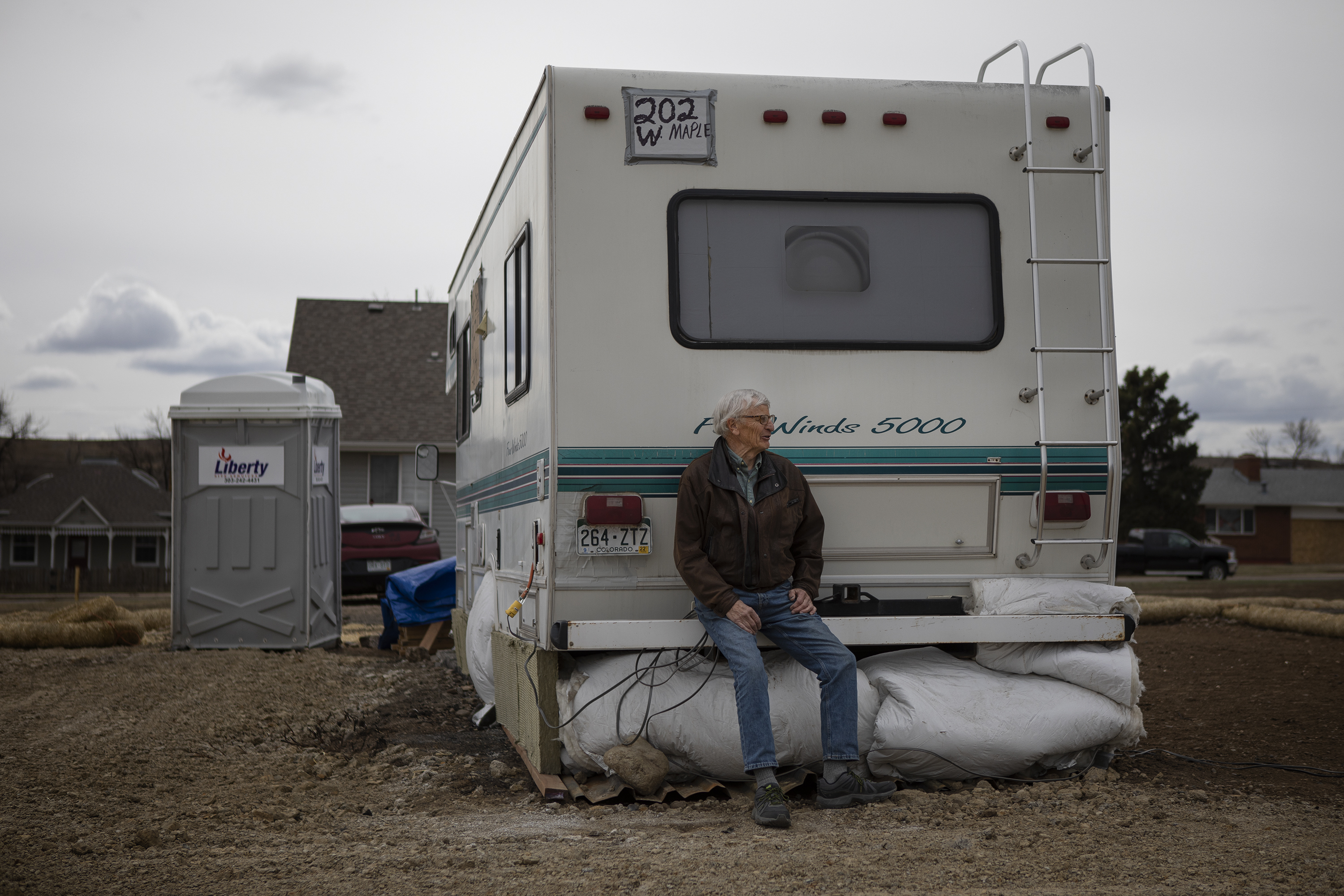 Superior resident Paul Williamson poses for a portrait while sitting on the bumper of his daughter’s camper that he’s been staying in while he cleared his property in the Original Town neighborhood on Wednesday, March 16, 2022, in Superior, Colo. (Timothy Hurst/The Denver Gazette) (Timothy Hurst)