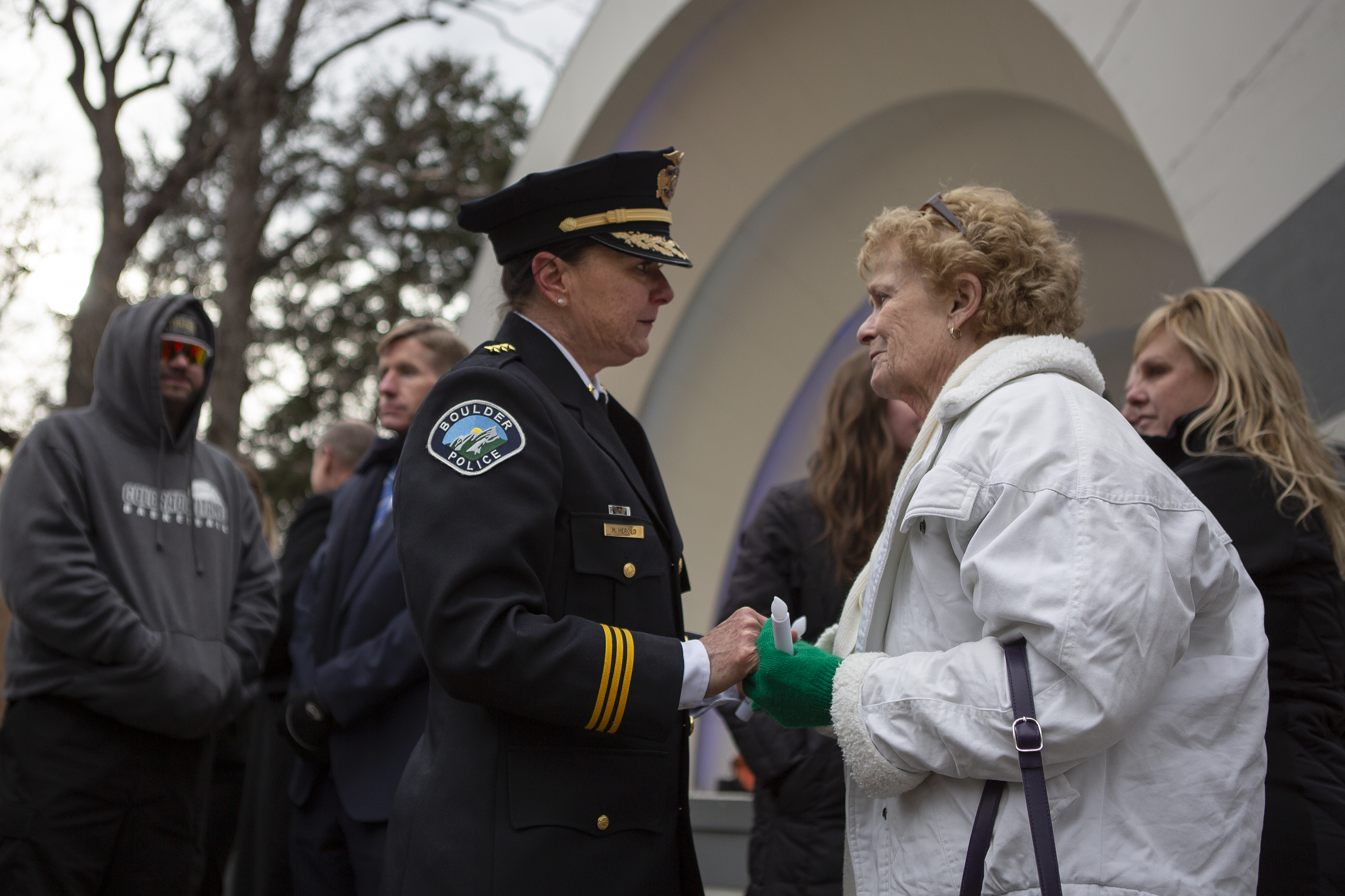 FILE PHOTO: Boulder Police chief Maris Herold talks with Margie Whittington, the mother of Teri Leiker, one of the ten victims of a mass shooting at the King Soopers in 2021, after a Communitywide Day of Remembrance gathering at the Glen Huntington Bandshell on Tuesday, March 22, 2022, in Boulder, Colo. (Timothy Hurst/The Denver Gazette) (Timothy Hurst/Denver Gazette)