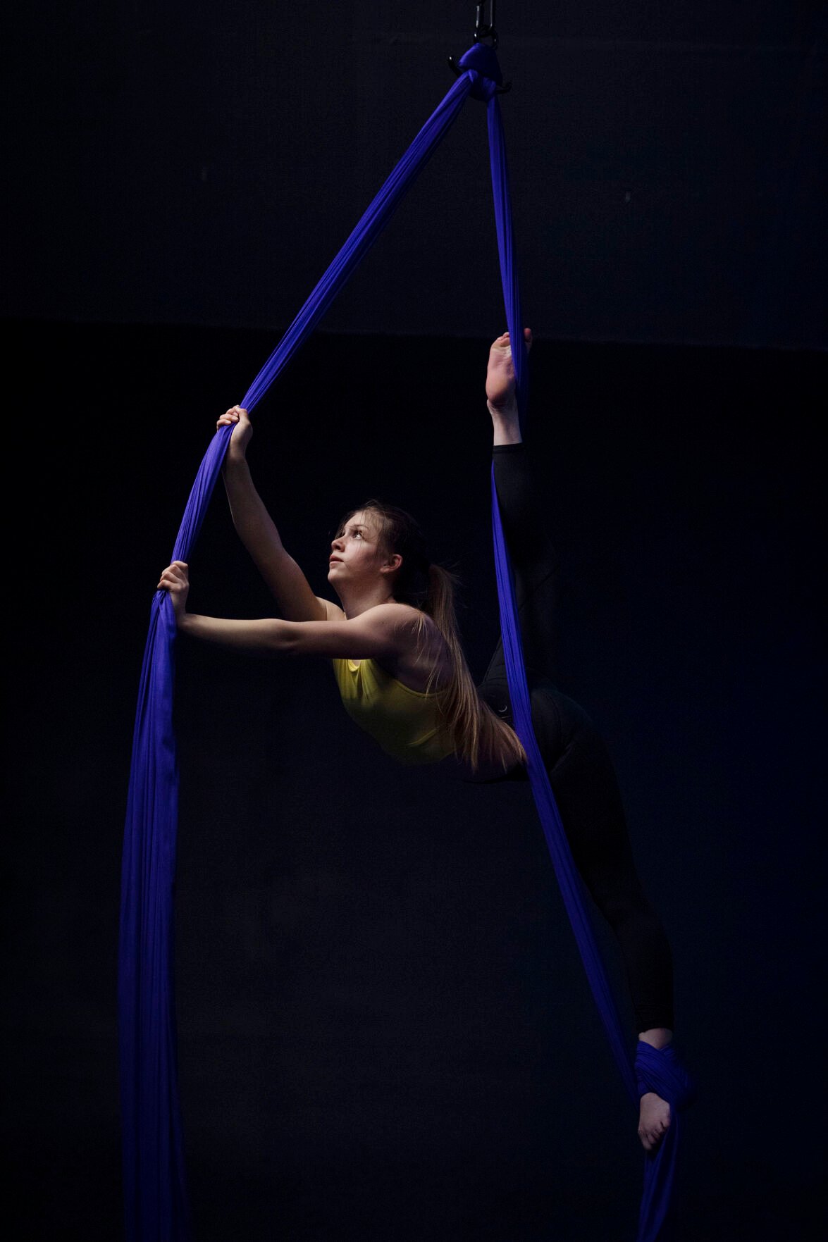 Adalyn Brown, 12, practices techniques during a teen intermediate aerial silk class at the Urban Cirque studio in Colorado Springs on Tuesday, March 15, 2022. Owner Katrina Diaz opened her studio in January, where she shares her passion of circus-style fitness with teens and adults, teaching the art of silks, hoops and aerial fitness ranging from beginner to intermediate classes. (Chancey Bush /The Gazette) (photos by Chancey Bush, The Gazette)