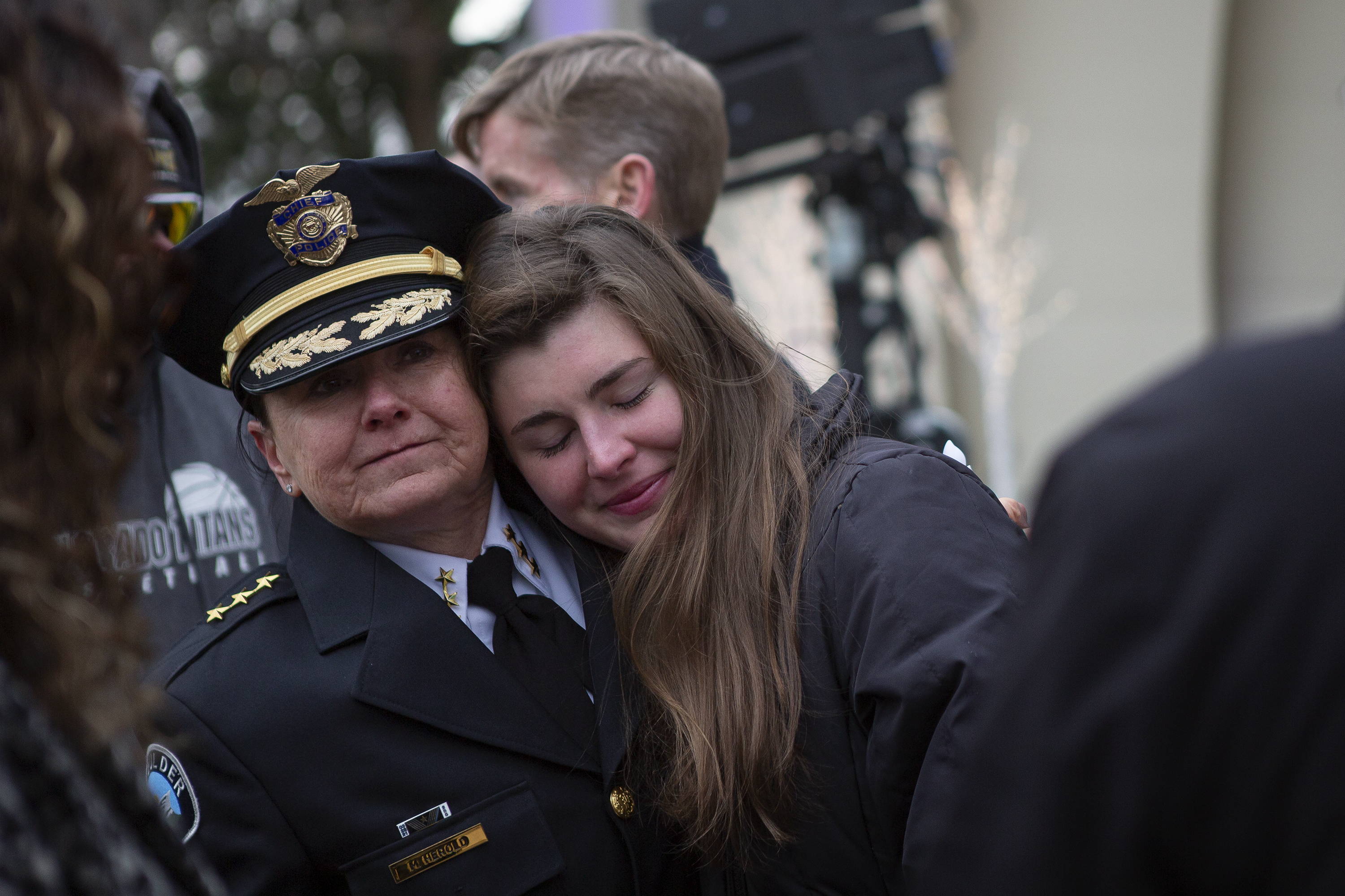 Boulder Police chief Maris Herold hugs Olivia Mackenzie, the daughter of Lynn Murray, one of the 10 victims of a mass shooting at the King Soopers one year ago, after a Communitywide Day of Remembrance gathering at the Glen Huntington Bandshell on March 22, 2022, in Boulder. (Timothy Hurst, Gazette file)