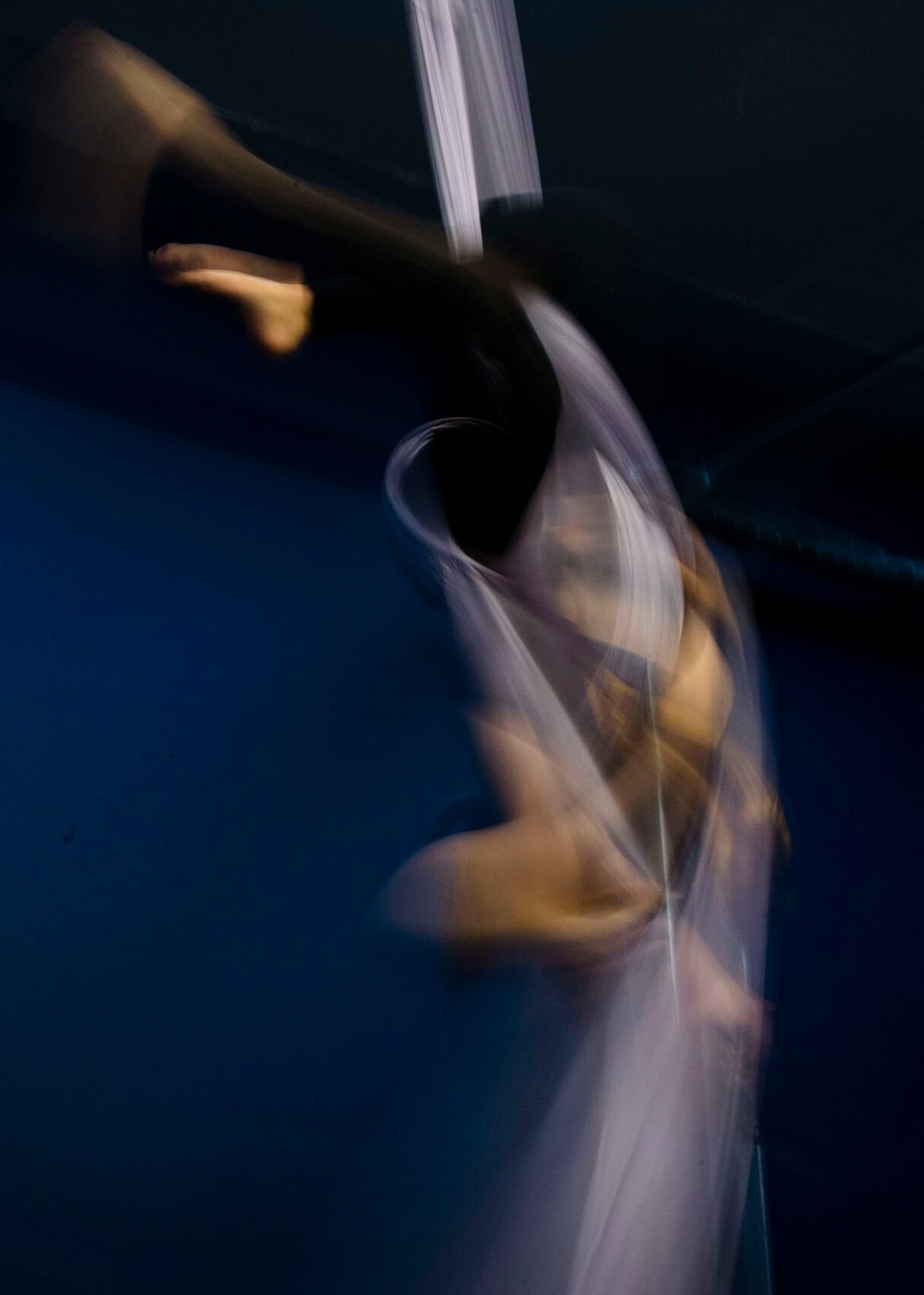Brianna Mix, 13, is suspended in the air by an aerial silk at Urban Cirque studio in Colorado Springs on Tuesday, March 15, 2022. Owner Katrina Diaz opened her studio in January, where she shares her passion of circus-style fitness with teens and adults, teaching the art of silks, hoops and aerial fitness ranging from beginner to intermediate classes. (Chancey Bush /The Gazette) (Chancey Bush/ The Gazette)