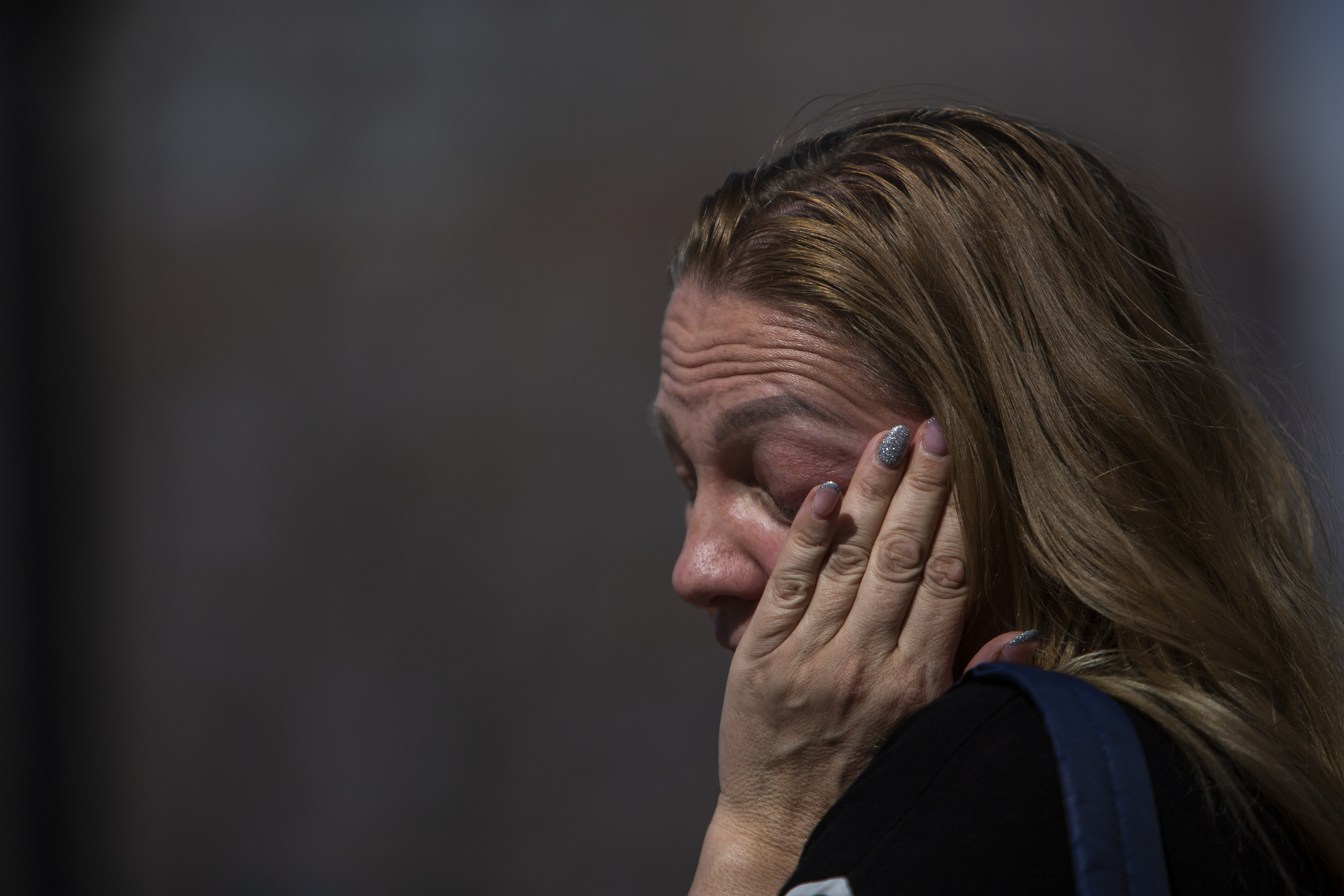Ukrainian Suitlana Oleksyn rests her face in her hand while taking with protest organizer Nataliia Bondarchuk during a protest outside the Colorado State Capitol in support of Ukraine on Wednesday, March 2, 2022, in Denver, Colo. The protest, organized through Ukrainians of Colorado, is requesting that the skies over Ukraine be sheltered, help the Ukrainian military with troops, and sending ammunition and financial help to Ukraine. (Timothy Hurst/The Denver Gazette) (Timothy Hurst)